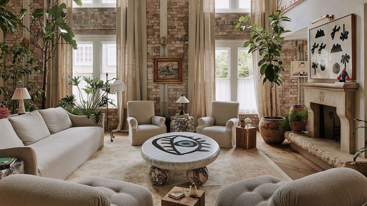 Image may contain: Home Decor, Plant, Lamp, Furniture, Table, Couch, Art, Painting, Architecture, Building, and Indoors