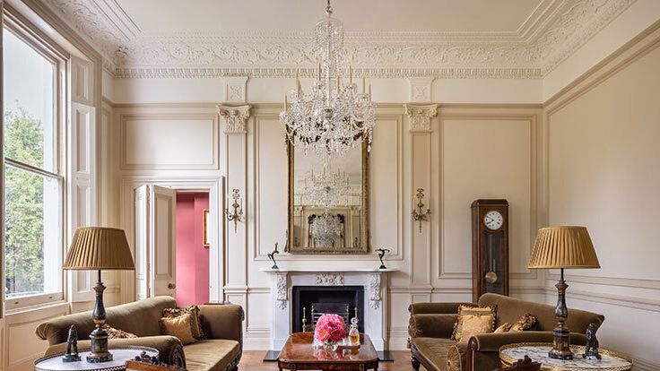 Image may contain: Home Decor, Lamp, Couch, Furniture, Table, Chandelier, Indoors, Interior Design, and Architecture