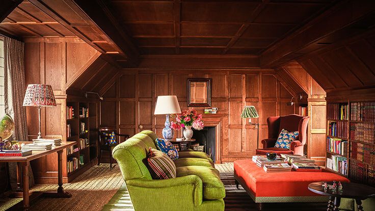 Image may contain: Lamp, Indoors, Interior Design, Desk, Furniture, Table, Chair, Home Decor, Couch, Rug, and Architecture