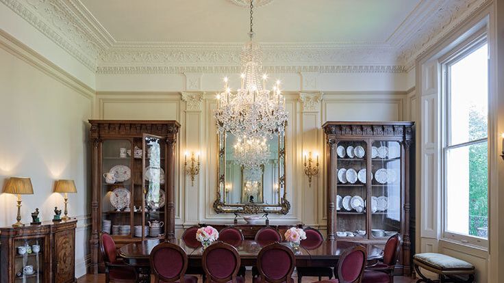 Image may contain: Architecture, Building, Dining Room, Dining Table, Furniture, Indoors, Room, Table, Chandelier, and Lamp