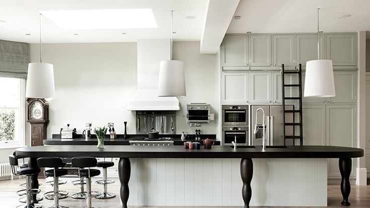 Image may contain: Indoors, Kitchen, Interior Design, Kitchen Island, Dining Table, Furniture, Table, Lamp, and Cooktop