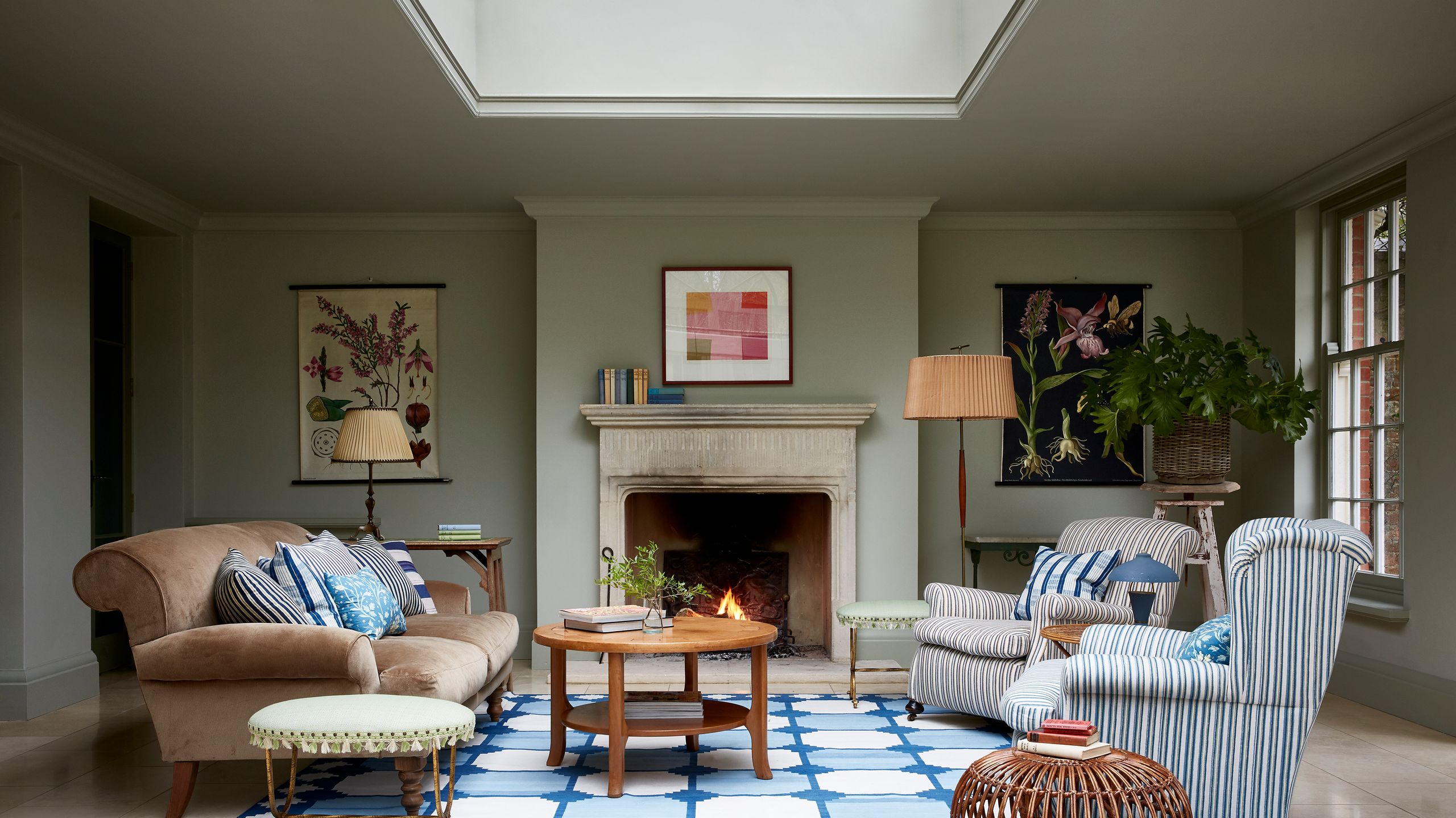 Image may contain: Home Decor, Rug, Lamp, Plant, Couch, Furniture, Table, Art, Painting, Coffee Table, and Architecture