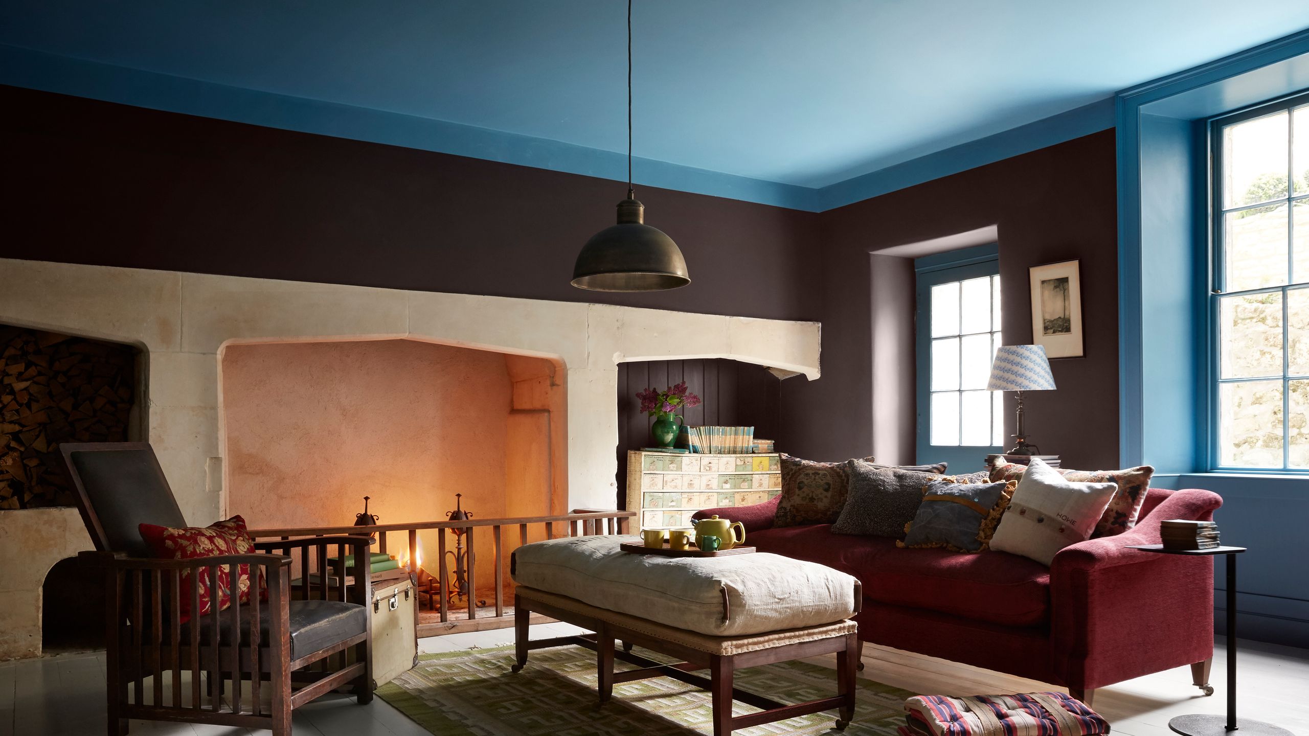 Image may contain: Home Decor, Lamp, Chair, Furniture, Couch, Cup, Art, Painting, Rug, Cushion, Architecture, and Building