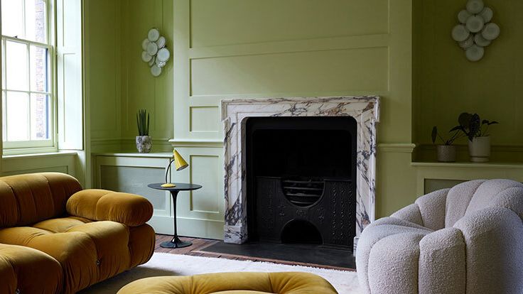 Image may contain: Furniture, Plant, Fireplace, Indoors, Couch, Desk, Table, and Lamp