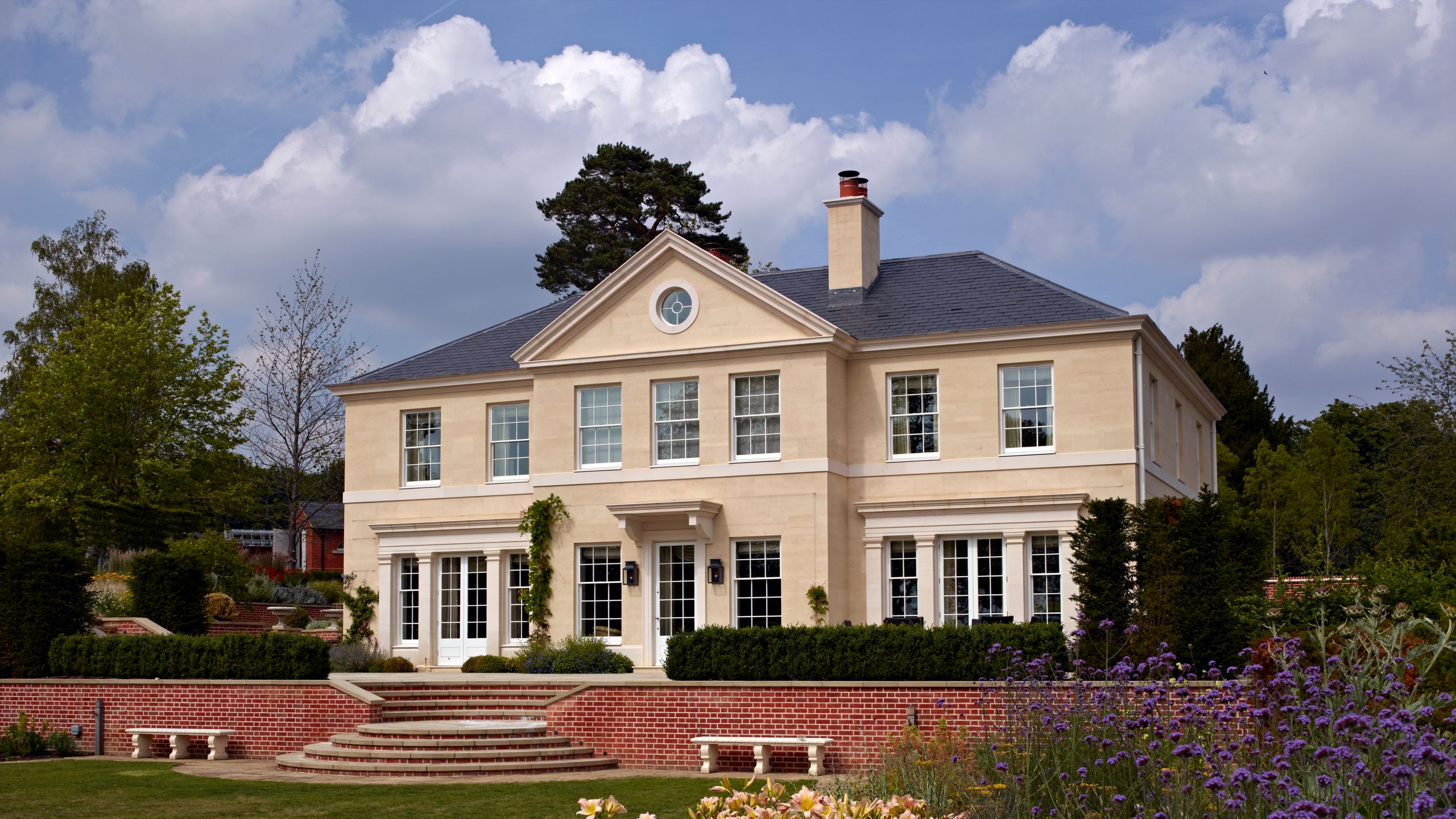 Image may contain: Bench, Furniture, Grass, Plant, Architecture, Building, Housing, House, Manor, Portico, and Outdoors
