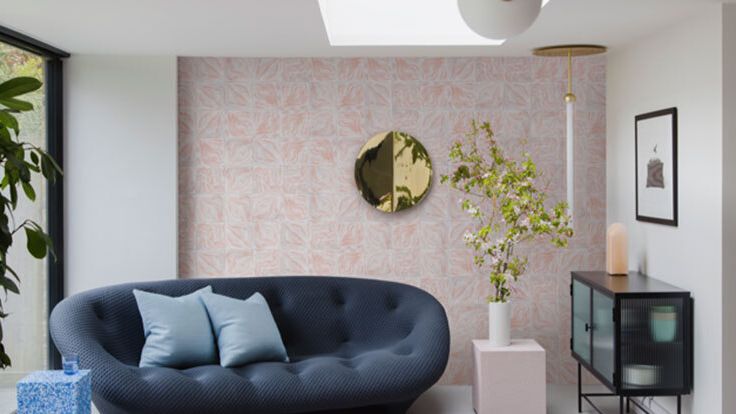 Image may contain: Home Decor, Architecture, Building, Furniture, Indoors, Living Room, Room, Cushion, and Plant