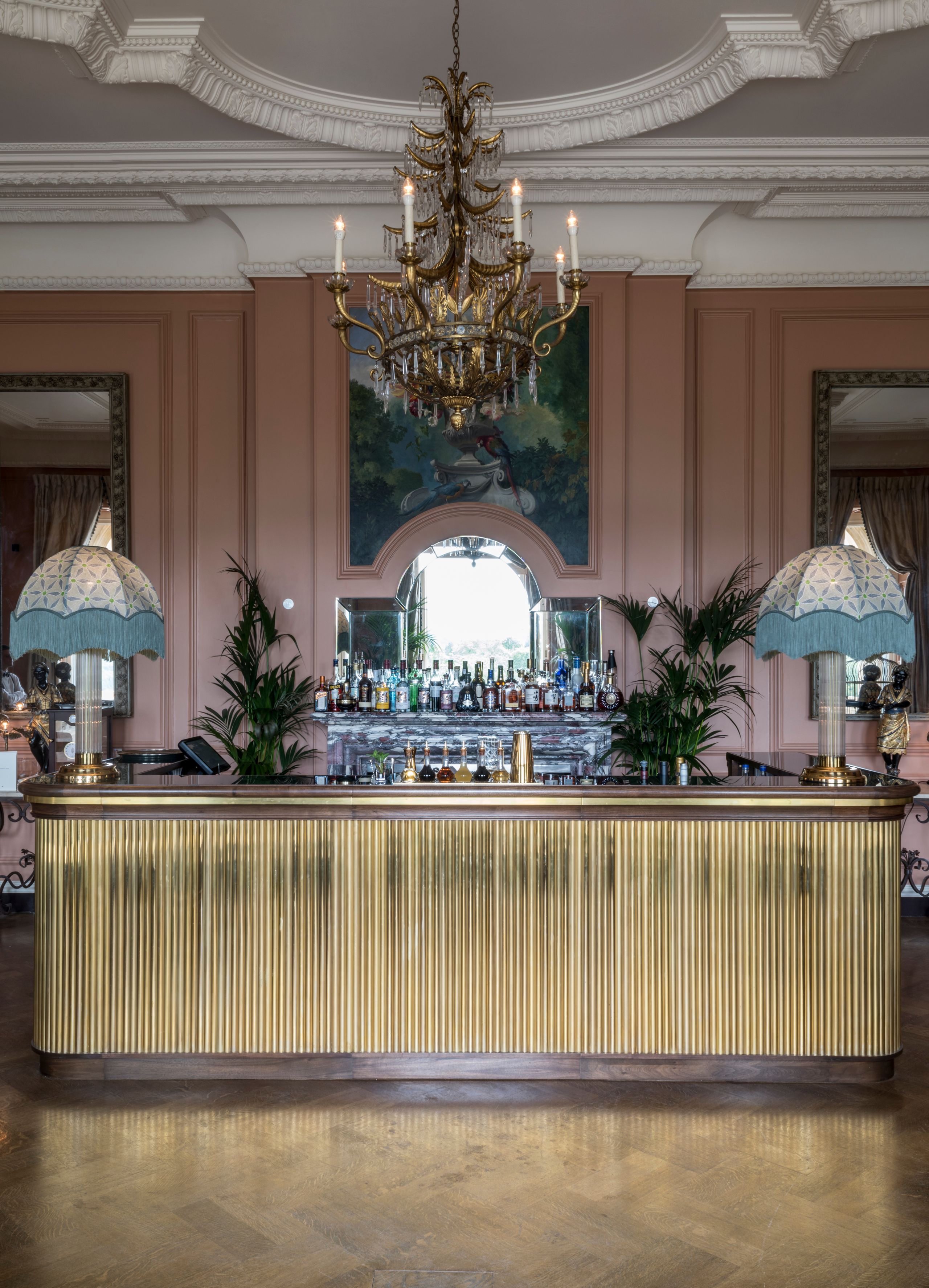 Image may contain: Chandelier, Lamp, Indoors, Interior Design, Person, Architecture, Building, Foyer, Furniture, and Table