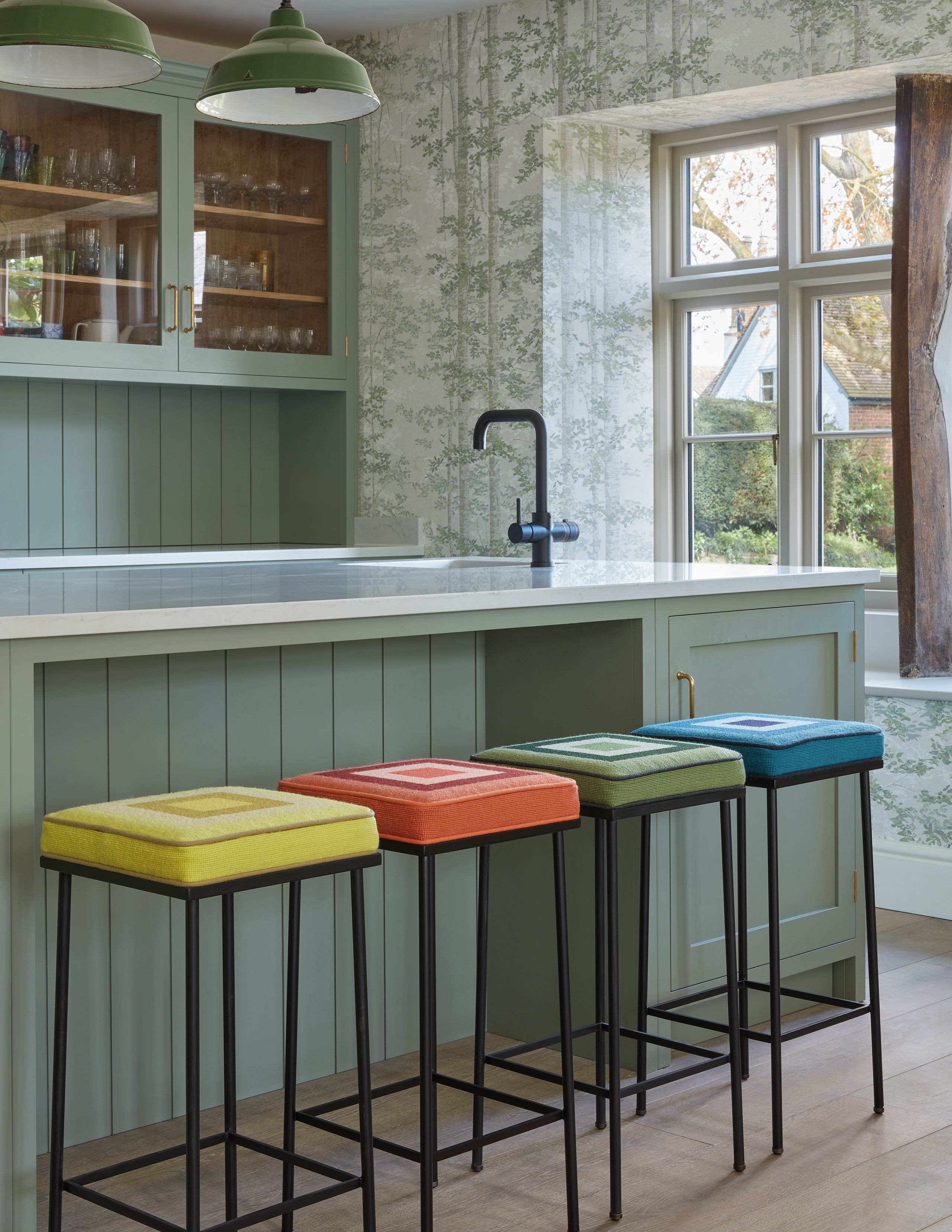 Image may contain: Bar Stool, Furniture, Lamp, Indoors, Interior Design, Sink, Sink Faucet, Cup, and Kitchen