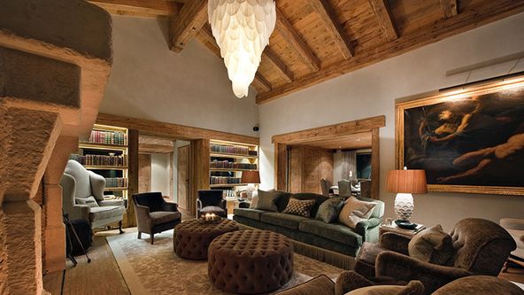 Image may contain: Lamp, Home Decor, Chair, Furniture, Couch, Art, Painting, Adult, Person, Architecture, and Building