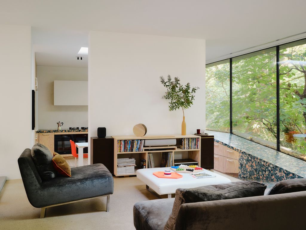 Image may contain Architecture Building Furniture Indoors Living Room Room Table Home Decor Couch and Coffee Table