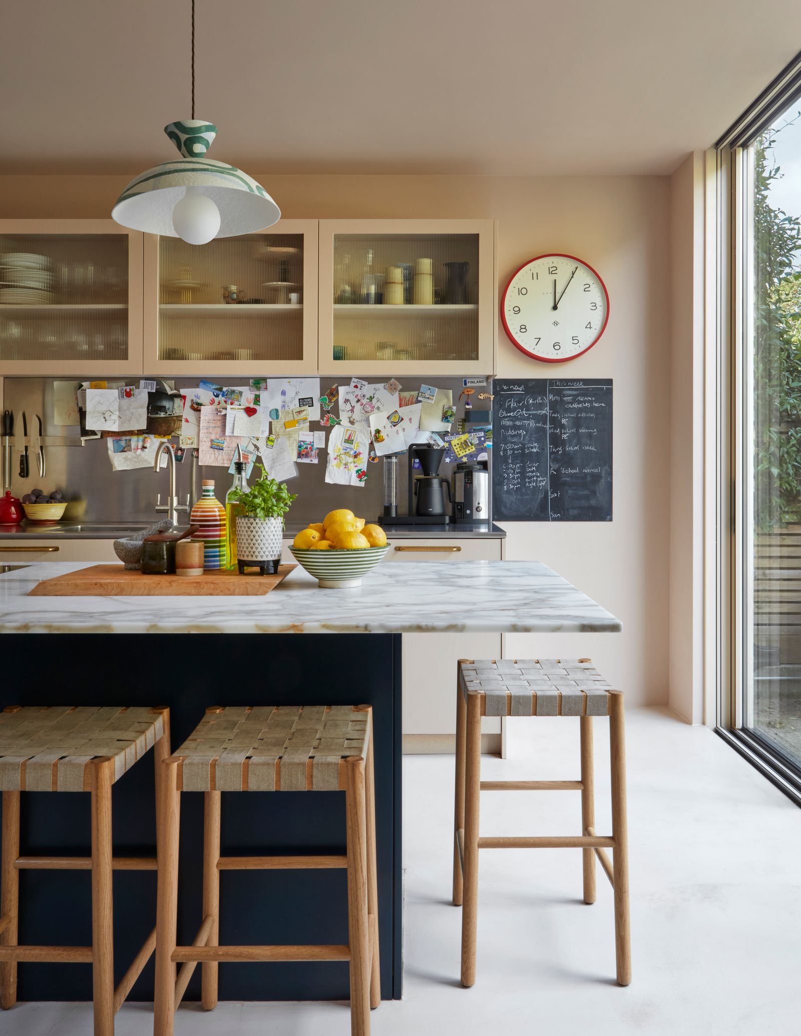 Image may contain Indoors Interior Design Kitchen Lamp Bar Stool Furniture Cup Kitchen Island and Dining Table