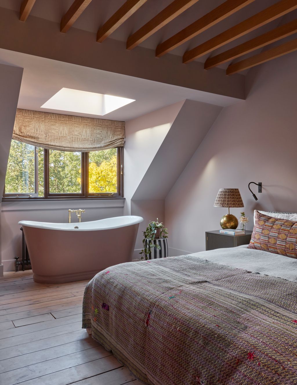 Image may contain Indoors Interior Design Lamp Plant Bathing Bathtub Person Tub Bed Furniture and Architecture