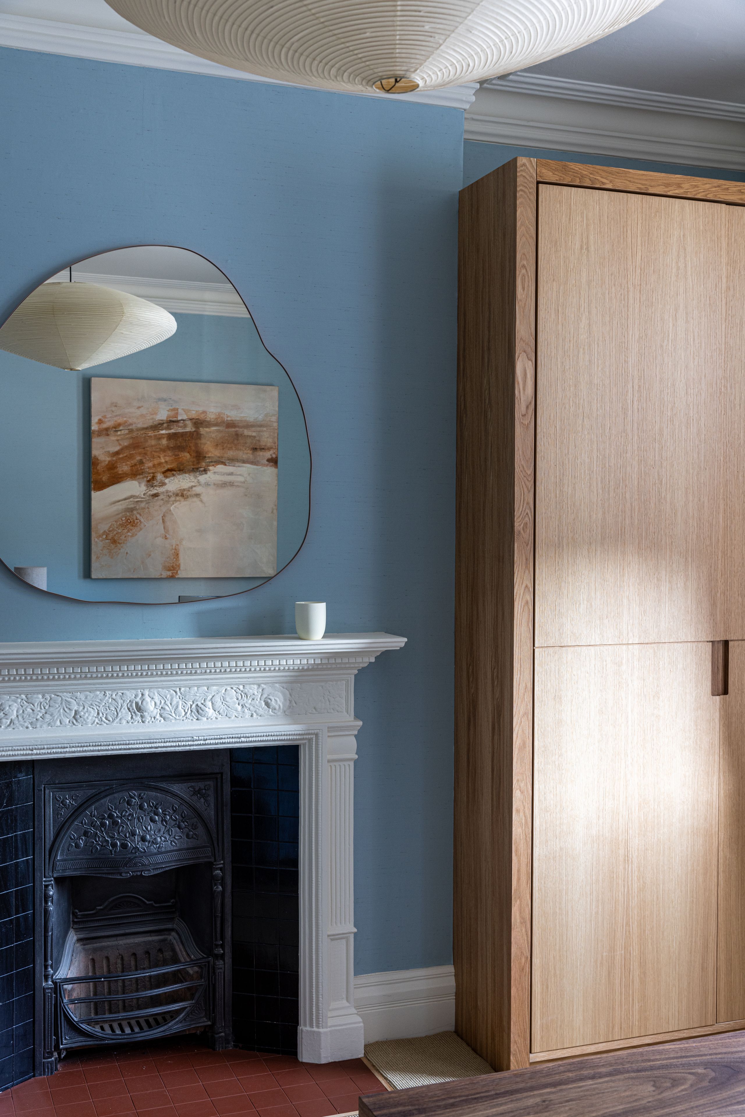 Image may contain: Indoors, Interior Design, Fireplace, Cup, Lamp, and Furniture