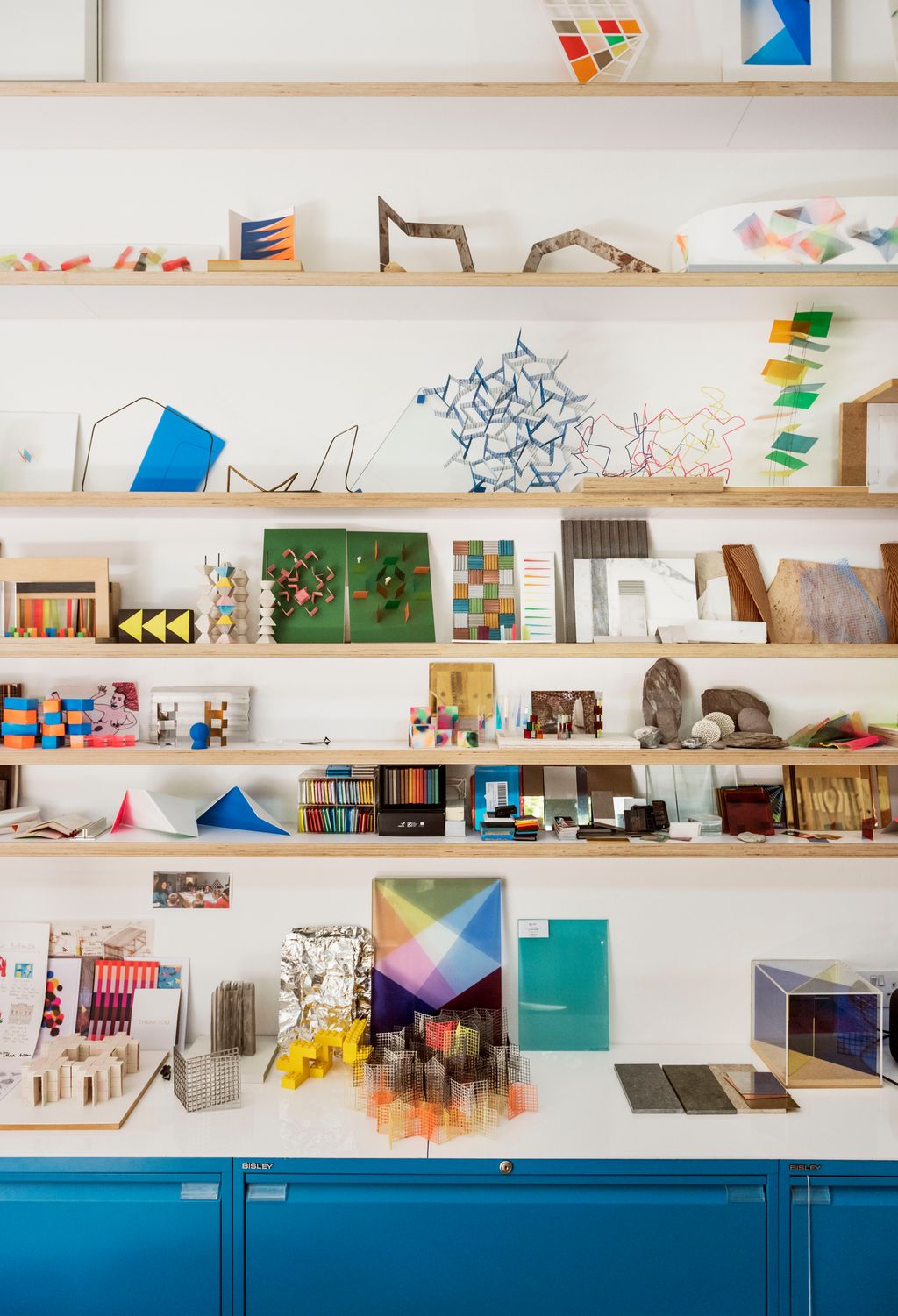 Image may contain Furniture Bookcase Shelf and Person