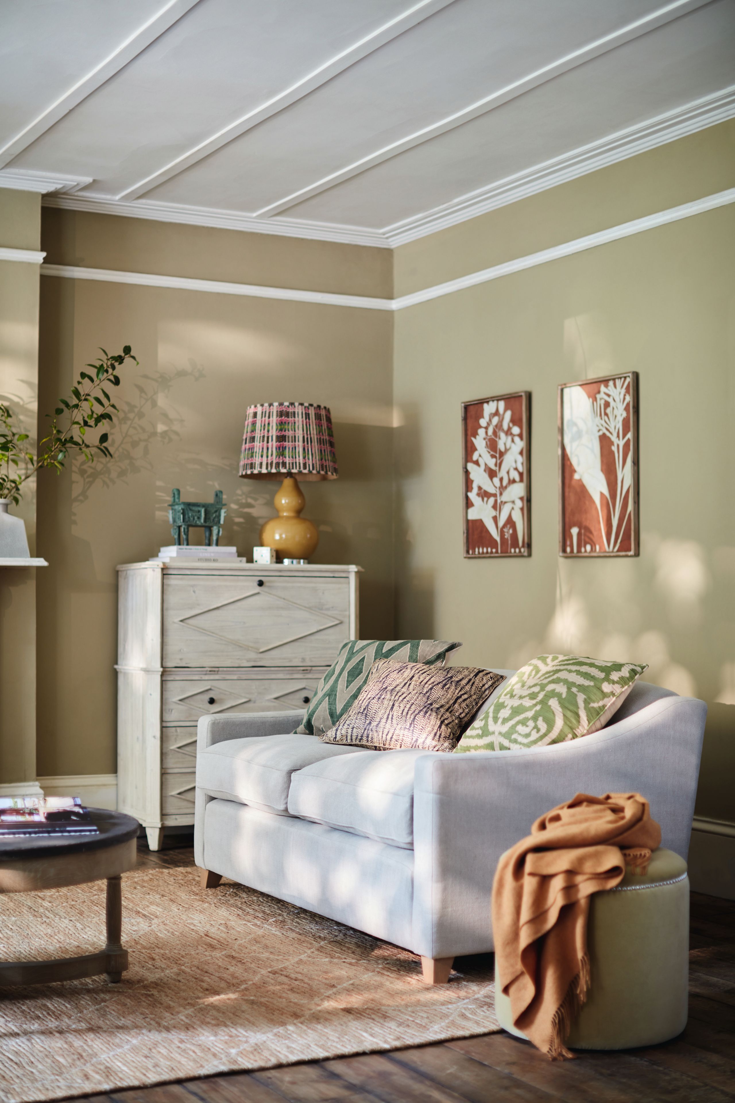 Image may contain: Home Decor, Lamp, Indoors, Interior Design, Couch, Furniture, Rug, Art, Painting, Desk, Table, and Cushion