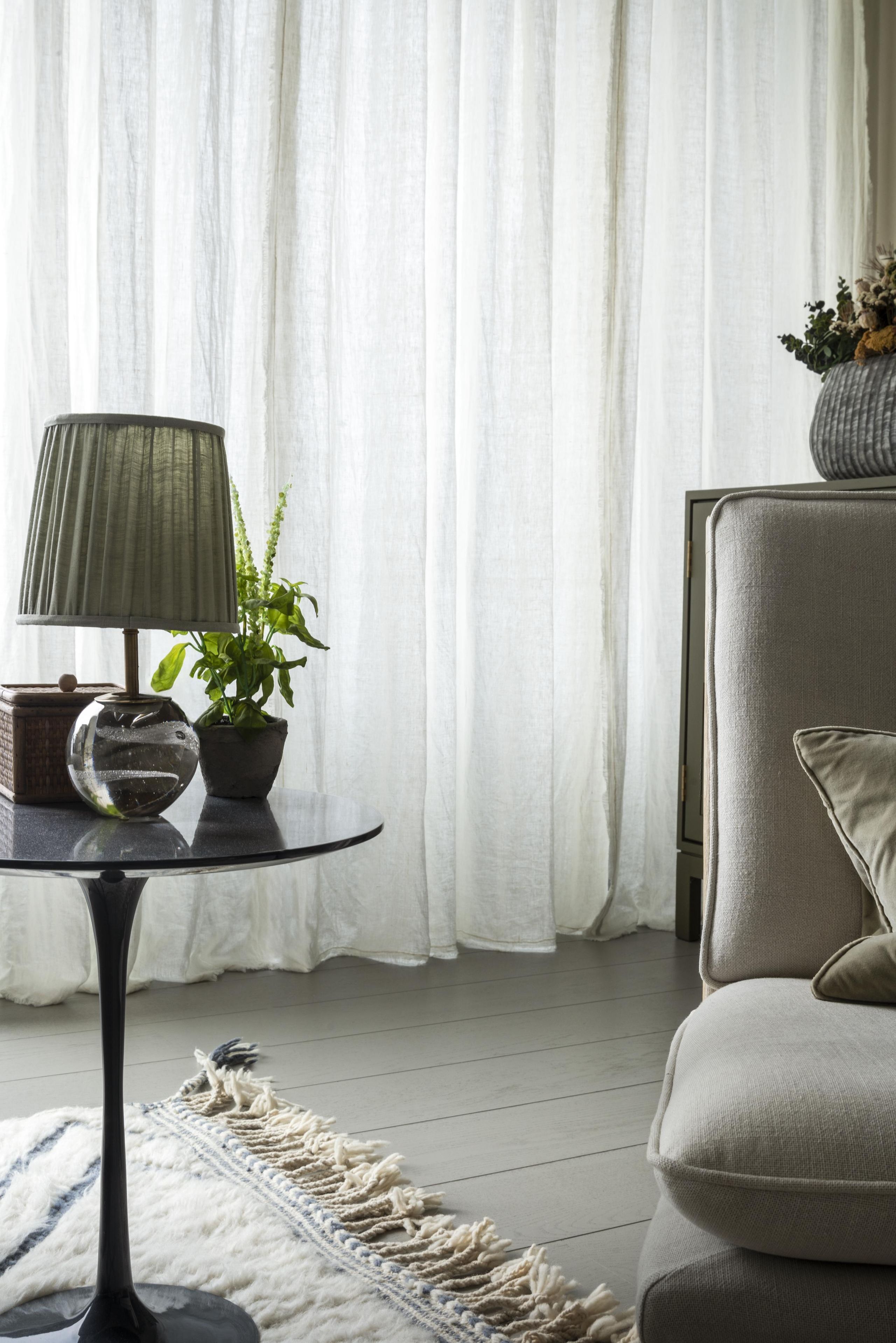 Image may contain: Lamp, Plant, Home Decor, Rug, Furniture, Table, and Floor Lamp