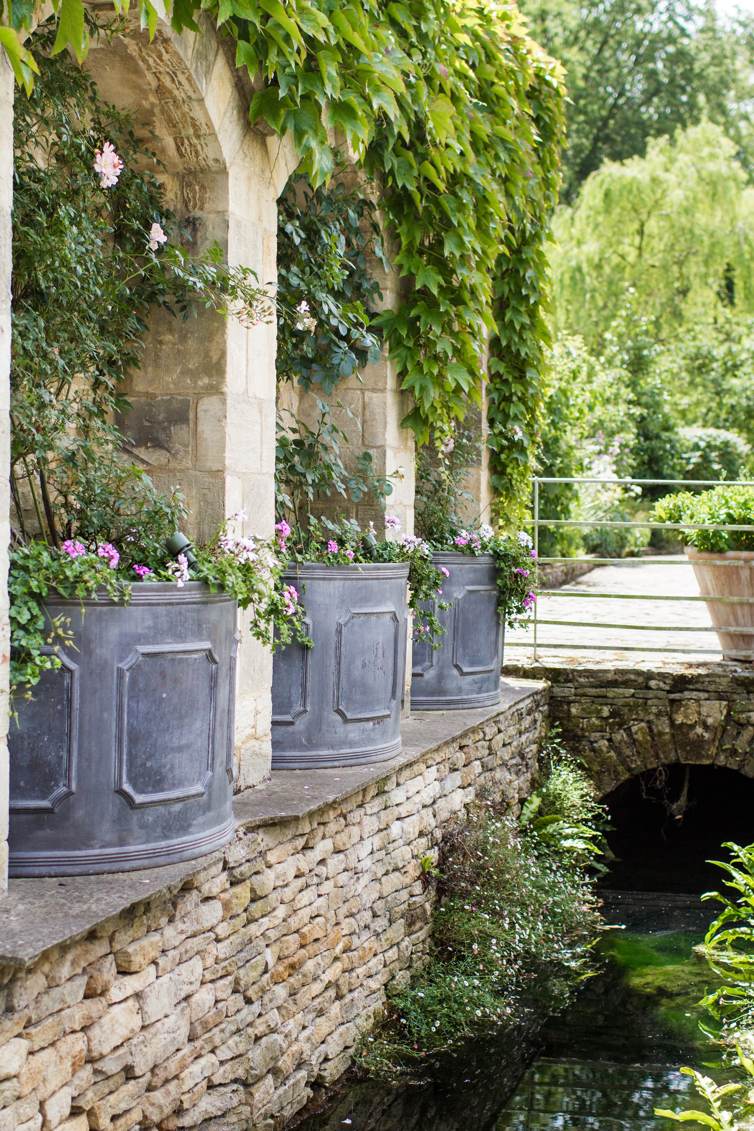 Image may contain: Jar, Plant, Planter, Potted Plant, Pottery, Vase, Path, Garden, Nature, Outdoors, Arbour, Canal, and Water