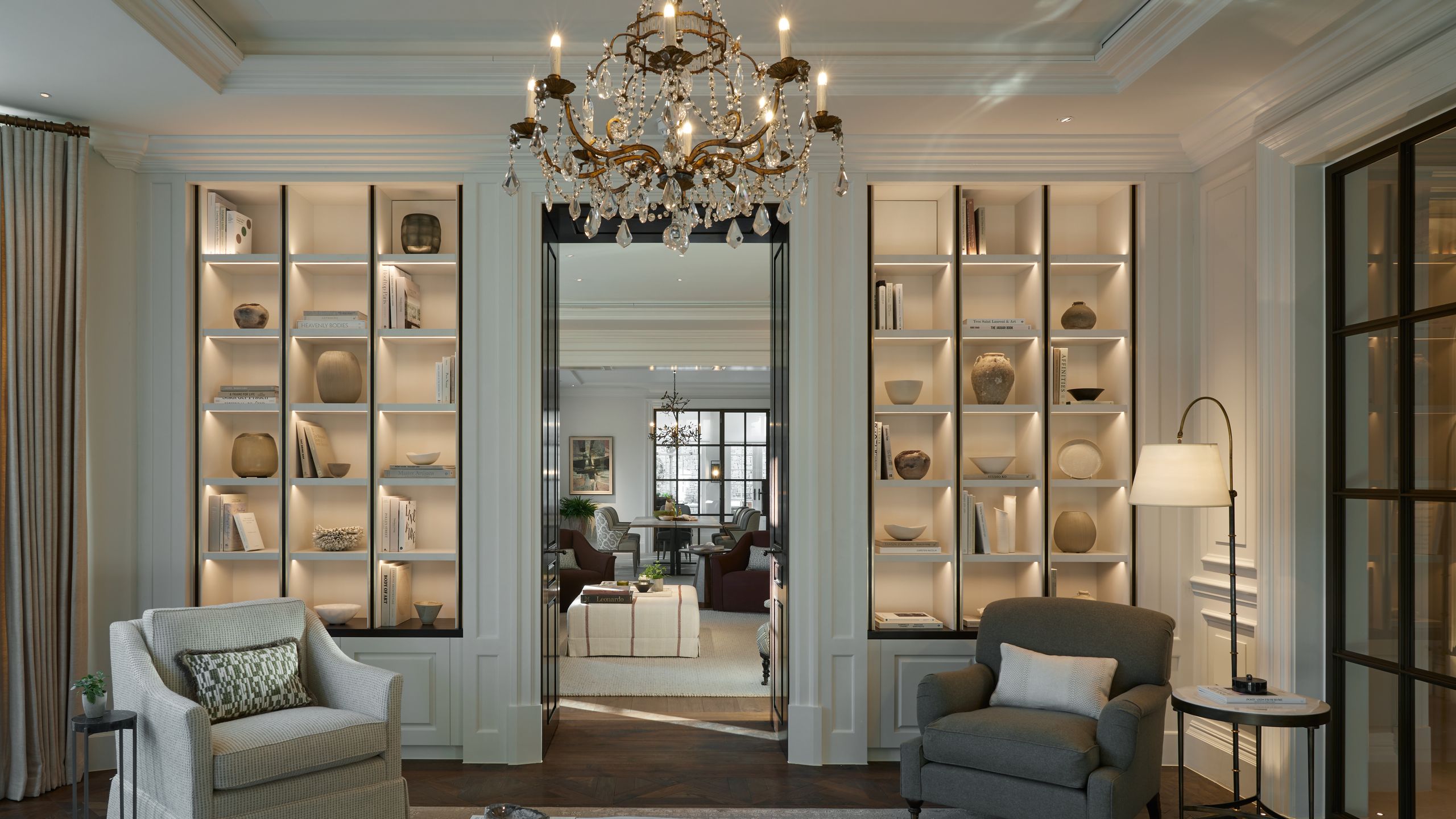 Image may contain: Lamp, Chandelier, Home Decor, Architecture, Building, Furniture, Indoors, Living Room, Room, and Book