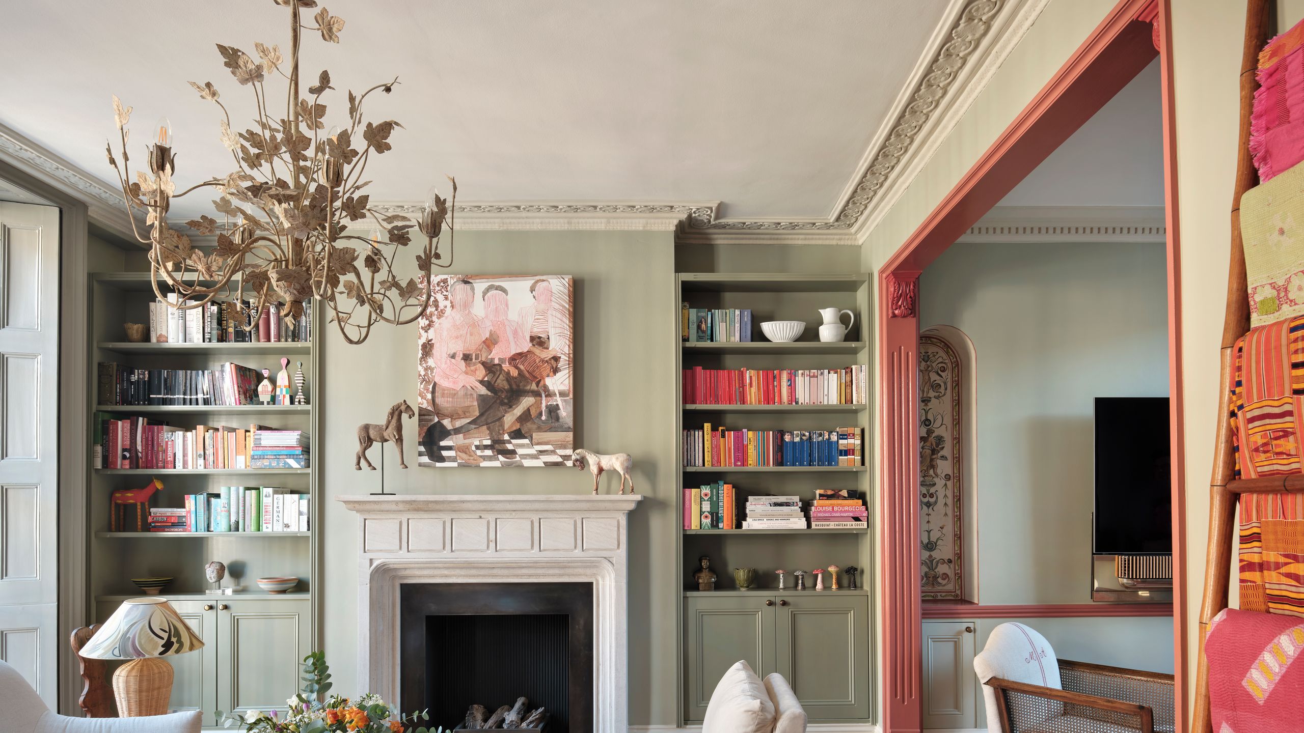 Image may contain: Home Decor, Book, Publication, Couch, Furniture, Fireplace, Indoors, Table, Architecture, and Building