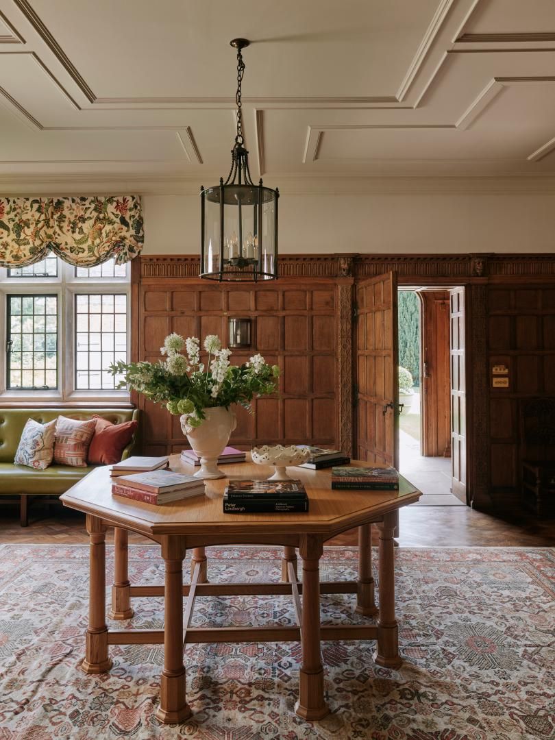 Image may contain: Indoors, Interior Design, Home Decor, Book, Publication, Furniture, Table, Rug, Lamp, and Architecture