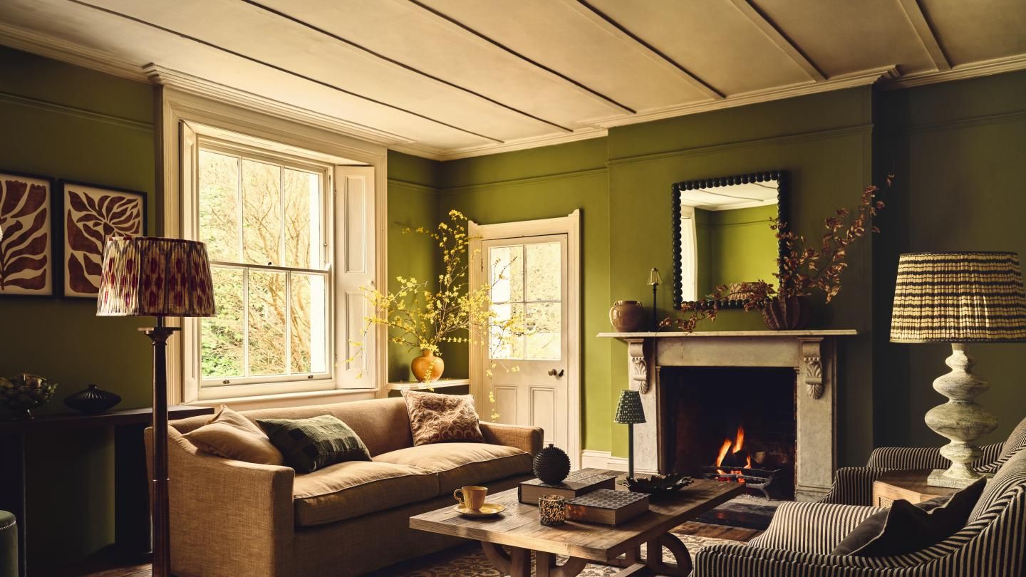 Image may contain: Home Decor, Lamp, Couch, Furniture, Fireplace, Indoors, Cup, Architecture, Building, Living Room, and Room