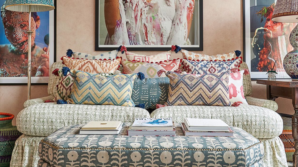 Image may contain: Cushion, Home Decor, Couch, Furniture, Art, Painting, Lamp, Pillow, Adult, Person, Wedding, and Desk