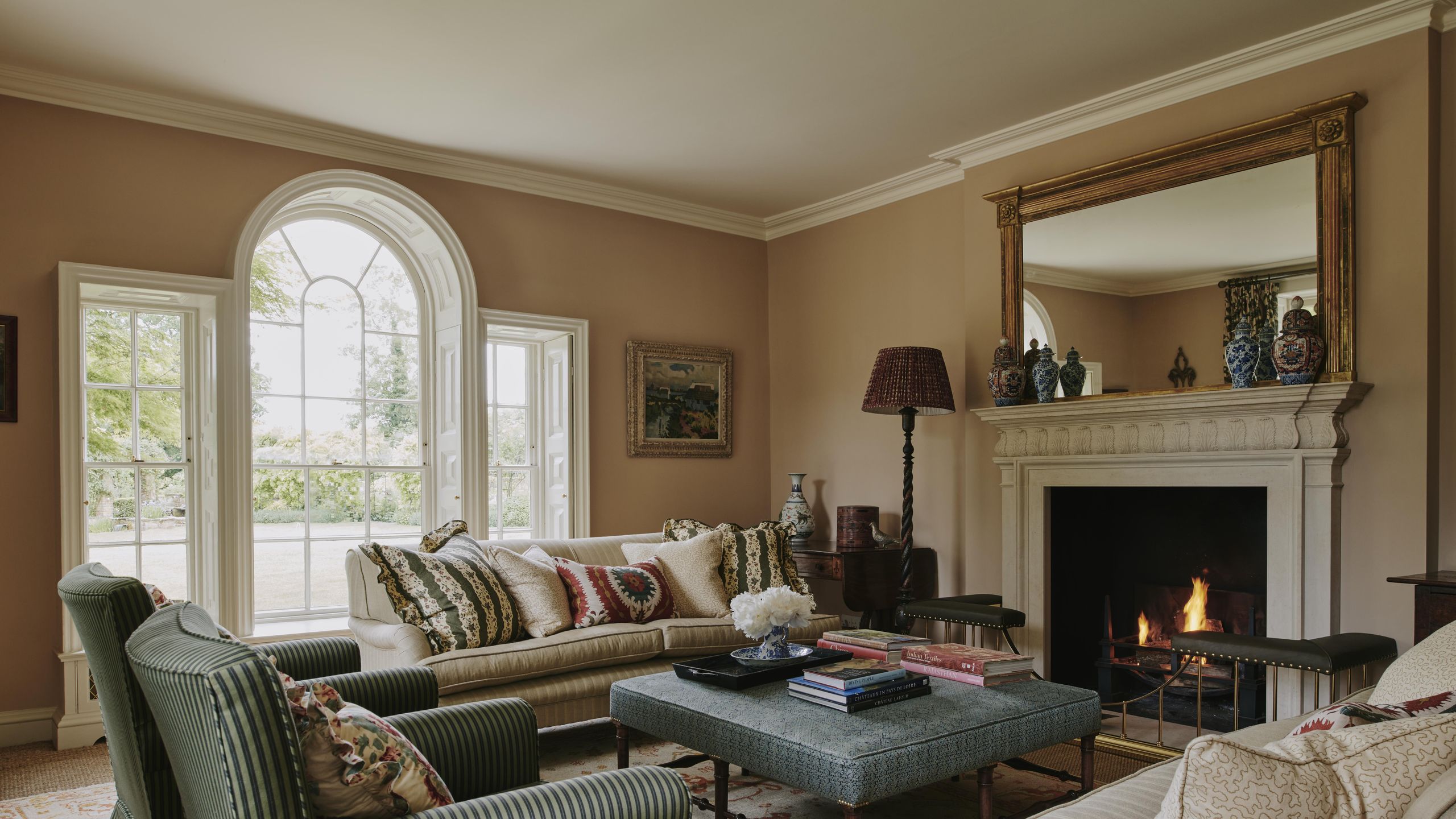 Image may contain: Lamp, Home Decor, Furniture, Couch, Architecture, Building, Indoors, Living Room, Room, Art, and Painting