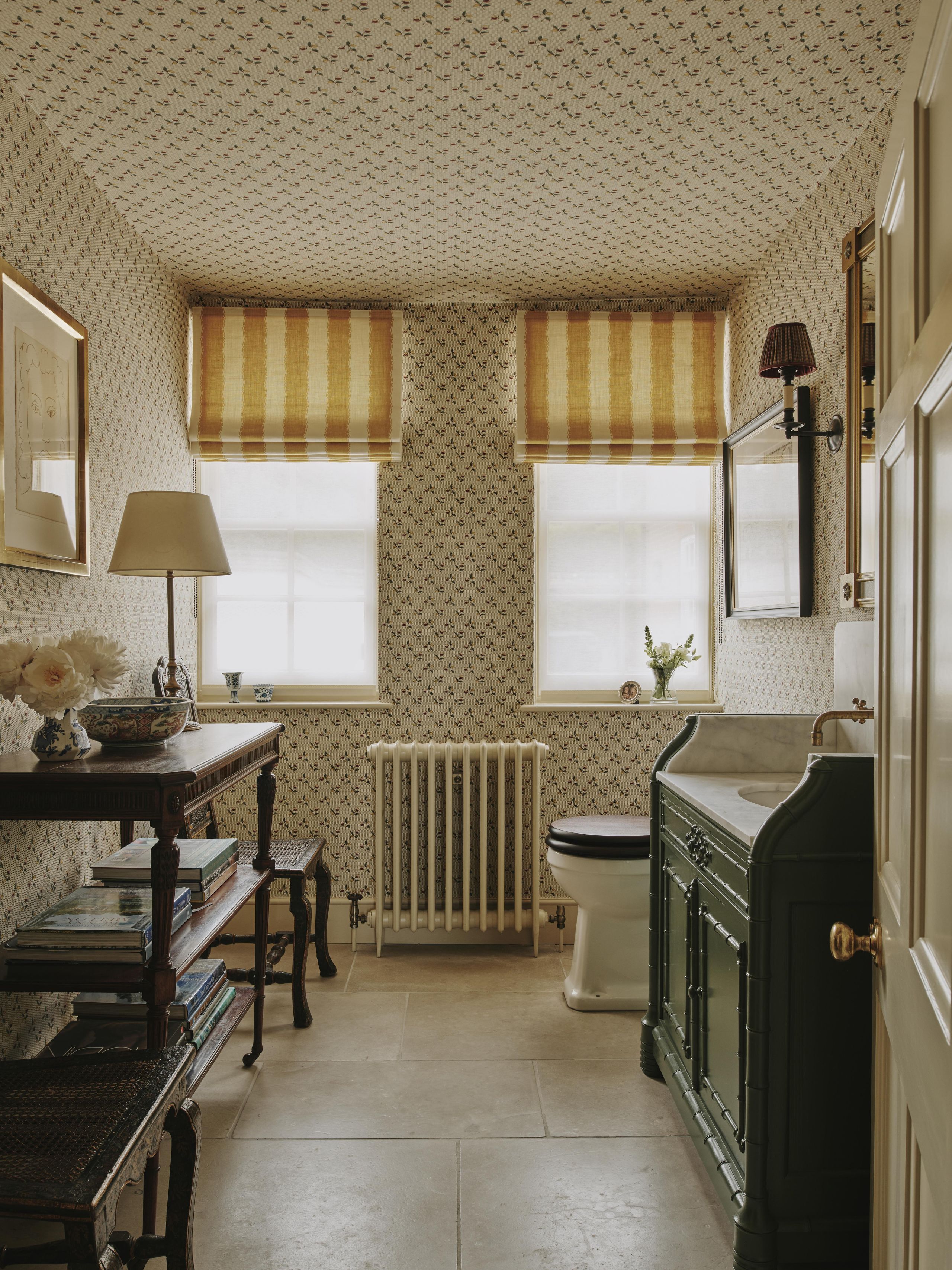 Image may contain: Lamp, Indoors, Interior Design, Sink, Sink Faucet, Art, Painting, Bathroom, Room, Toilet, and Plant