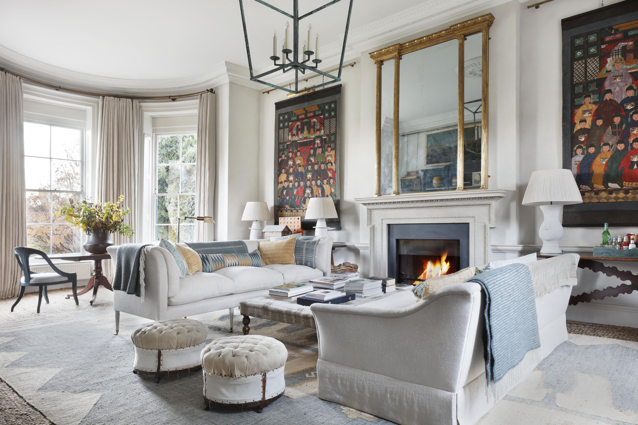 Image may contain: Home Decor, Chair, Furniture, Fireplace, Indoors, Lamp, Couch, Table, Architecture, and Building