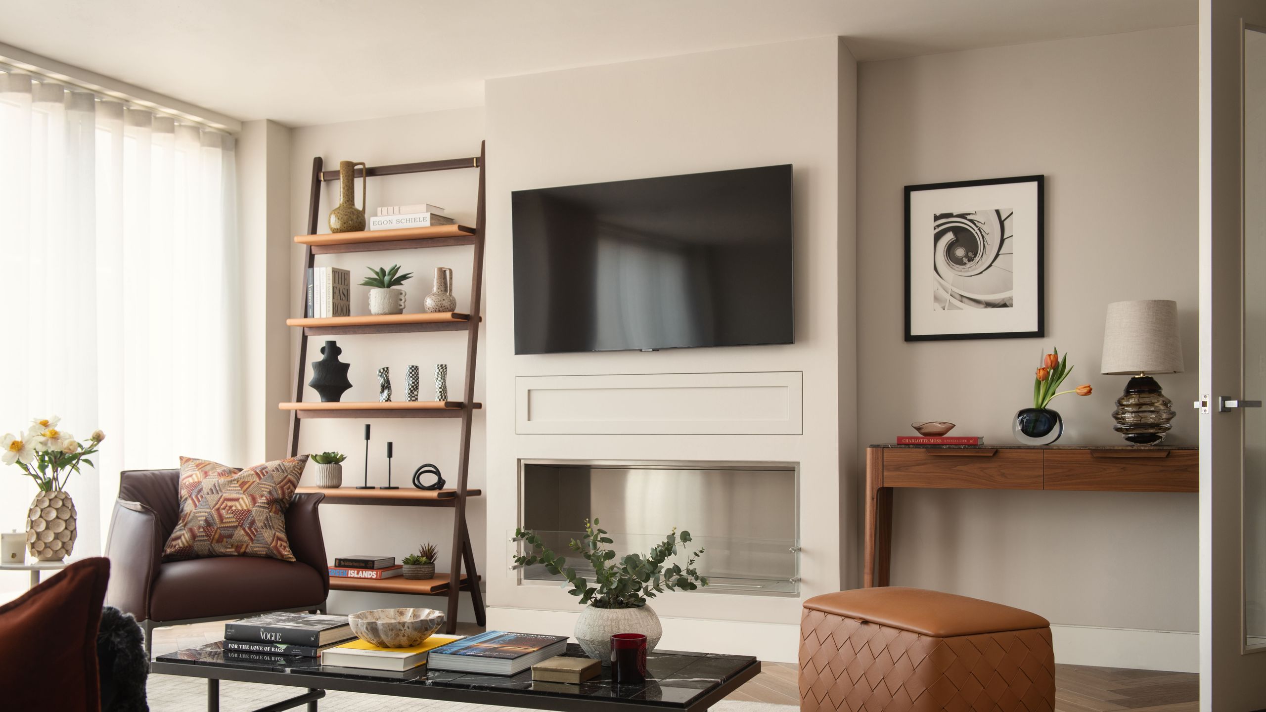 Image may contain: Architecture, Building, Furniture, Indoors, Living Room, Room, Plant, Book, Publication, and Home Decor