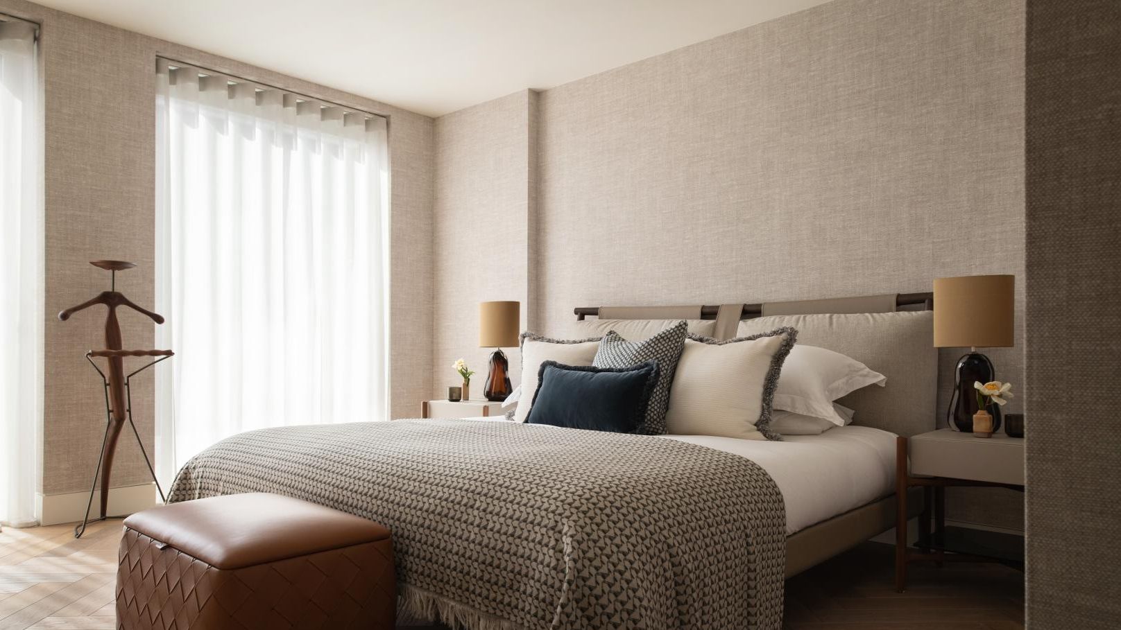Image may contain: Lamp, Bed, Furniture, Indoors, Interior Design, Home Decor, Cushion, Person, Bedroom, Room, and Bench