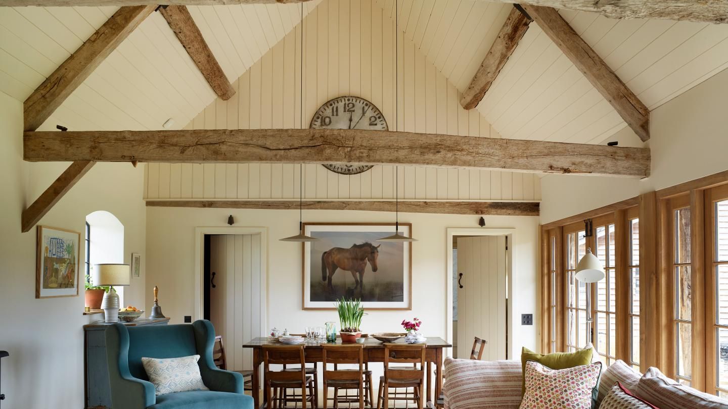 Image may contain: Home Decor, Plant, Couch, Furniture, Lamp, Book, Publication, Art, Painting, Chair, and Architecture