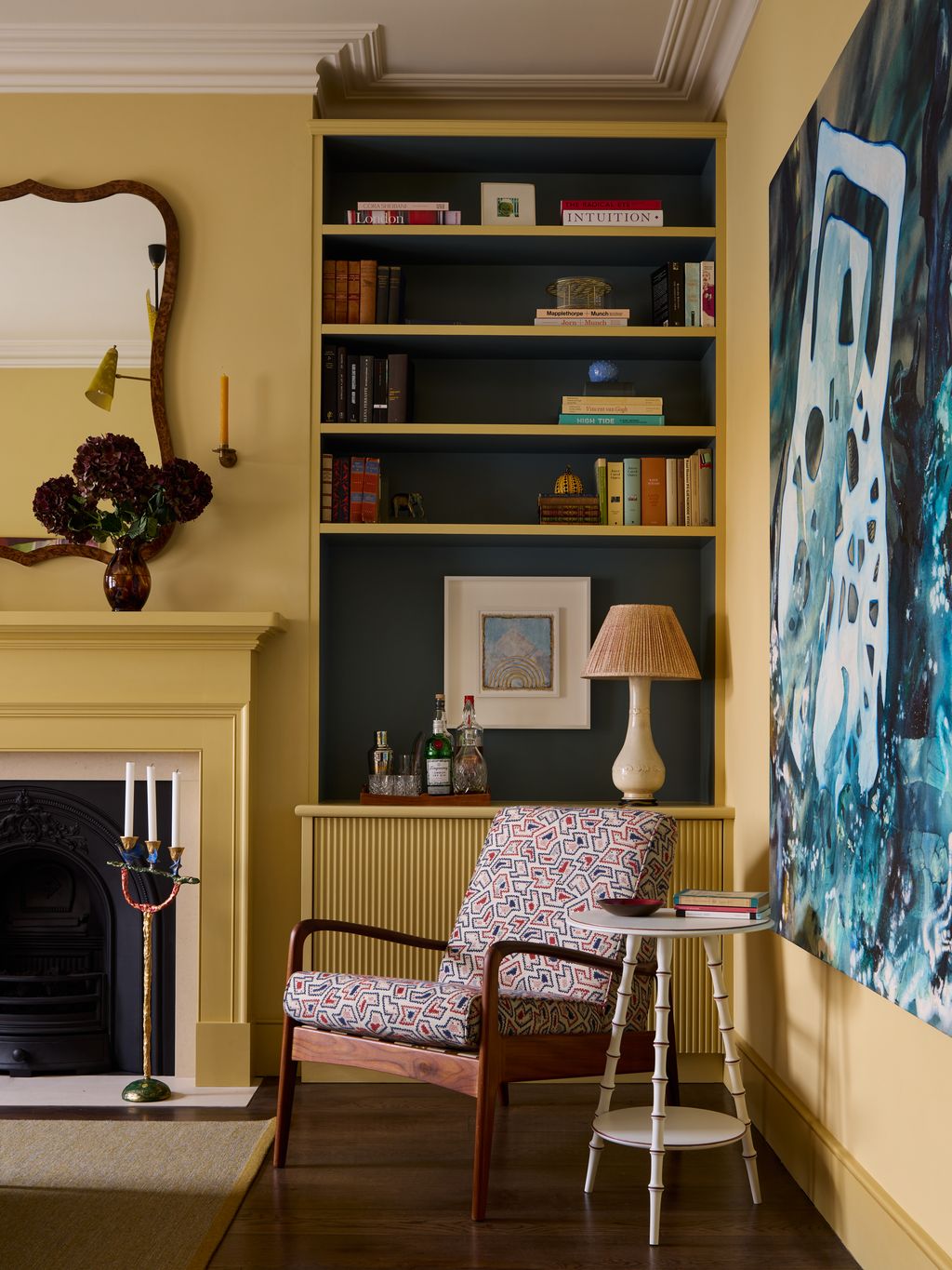 Image may contain Indoors Interior Design Chair Furniture Lamp Desk Table Book Publication Art and Painting