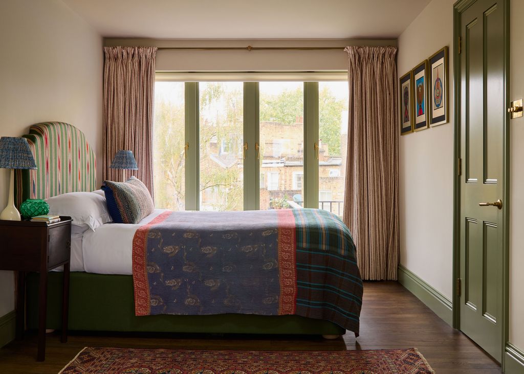 Image may contain Lamp Bed Furniture Indoors Interior Design Door Home Decor Rug Art Painting and Book