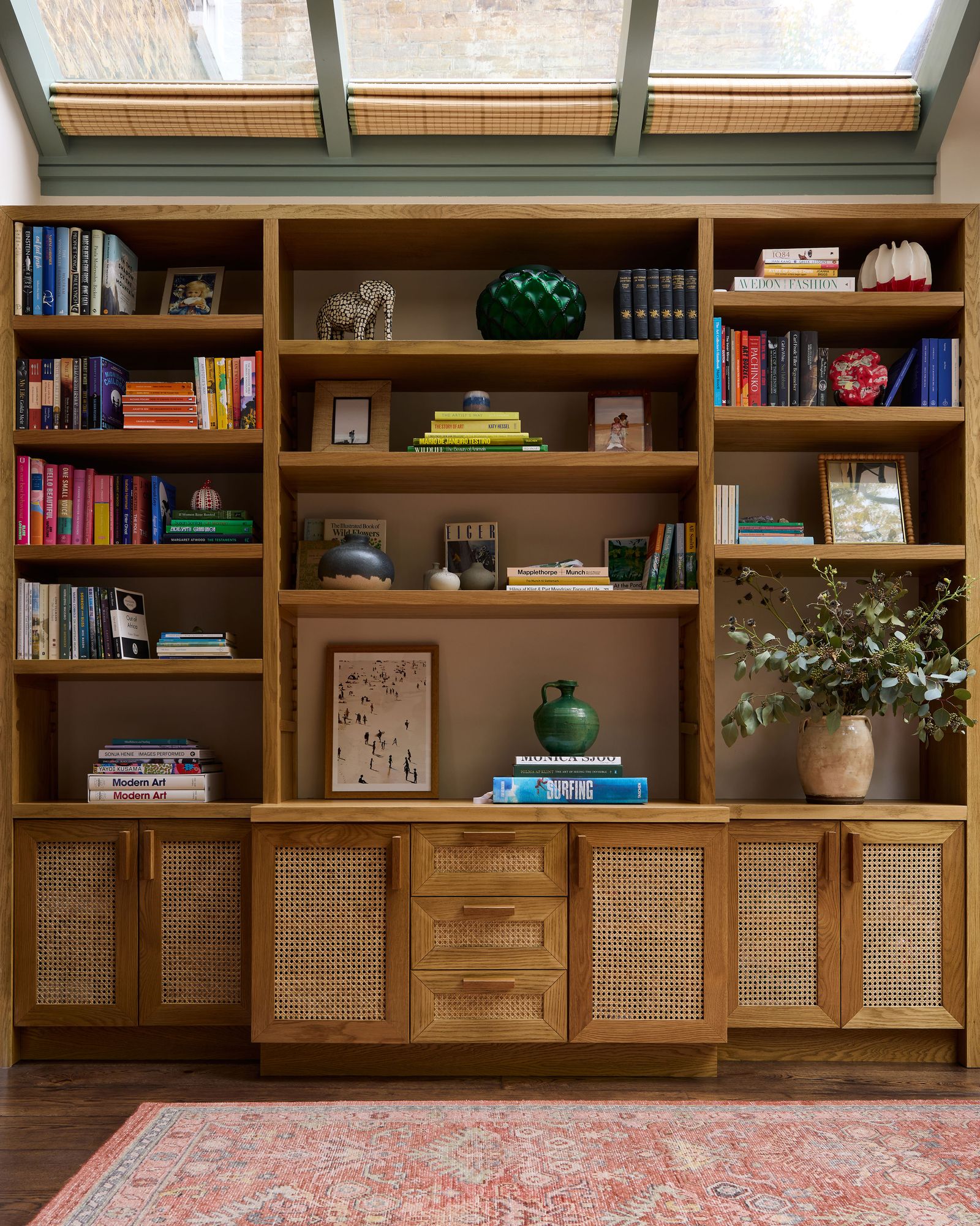 Image may contain Furniture Bookcase Home Decor Rug Plant Wood Art Painting and Hardwood