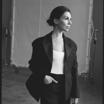 Image may contain: Clothing, Coat, Face, Happy, Head, Person, Smile, Photography, Portrait, Formal Wear, Suit, and Blazer