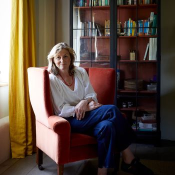 Image may contain: Person, Sitting, Adult, Chair, Furniture, Clothing, Footwear, Shoe, Accessories, Jewelry, and Necklace