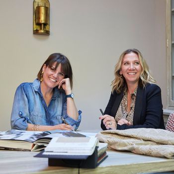 Image may contain: Maggie Gyllenhaal, Adult, Person, Pen, Wristwatch, Accessories, Jewelry, Ring, Desk, Furniture, and Table