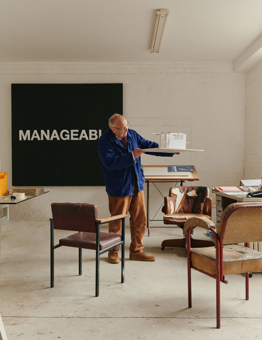 Image may contain Furniture Table Desk Chair Clothing Footwear Shoe Lamp Adult Person Accessories and Glasses