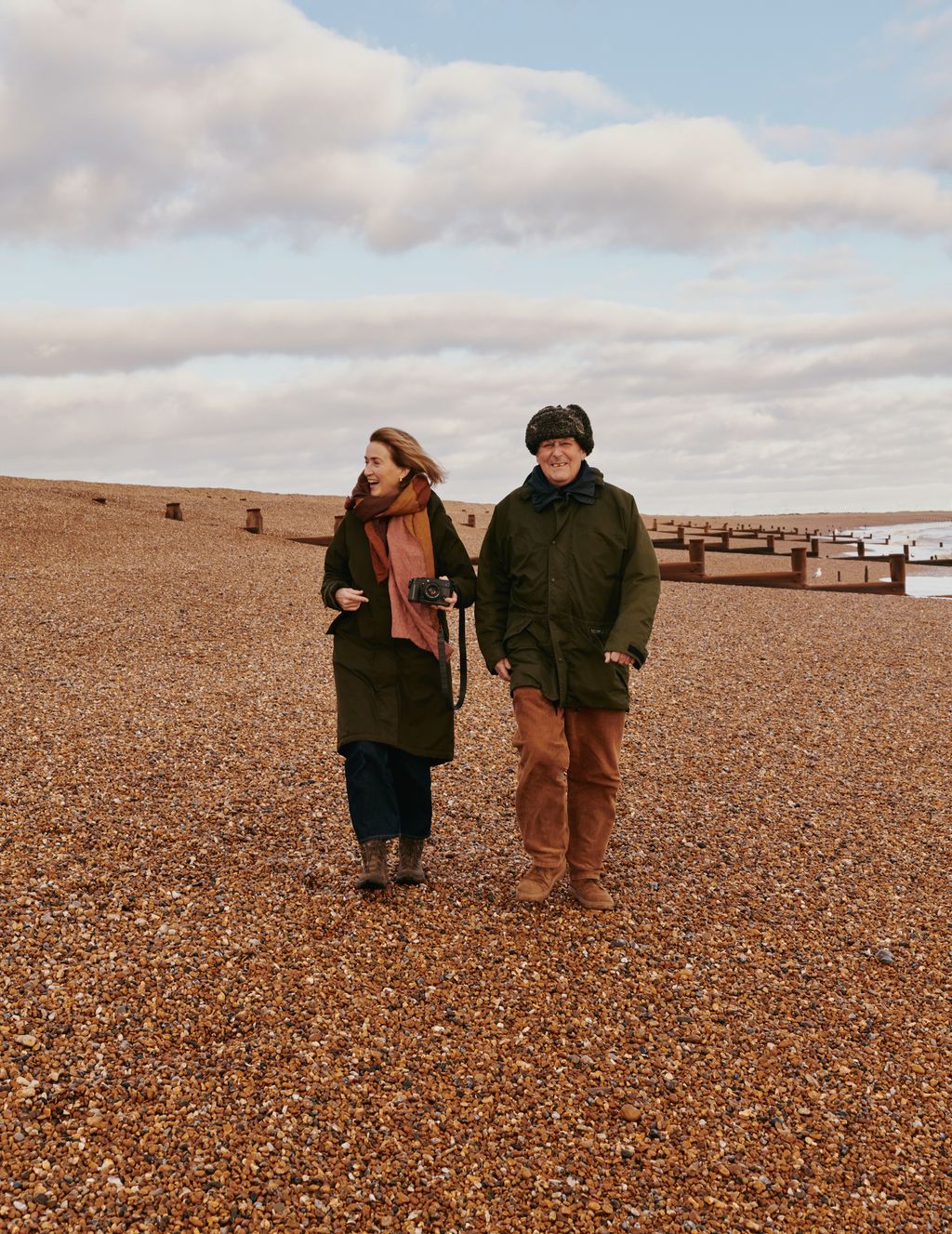 Image may contain Clothing Coat Jacket Photography Face Head Person Portrait Walking Pants Adult Beach and Coast