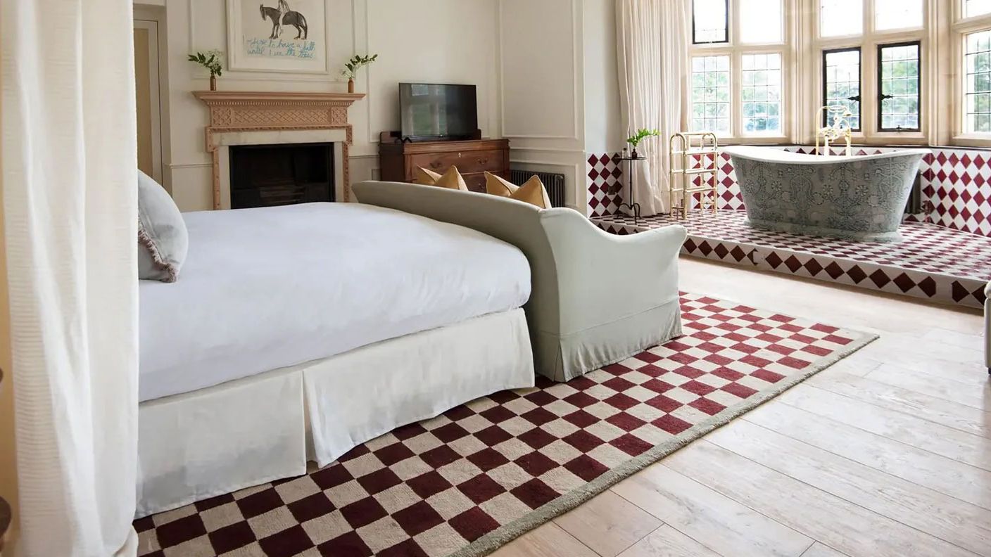 Image may contain: Home Decor, Rug, Indoors, Interior Design, Bathing, Bathtub, Person, Tub, and Computer Hardware