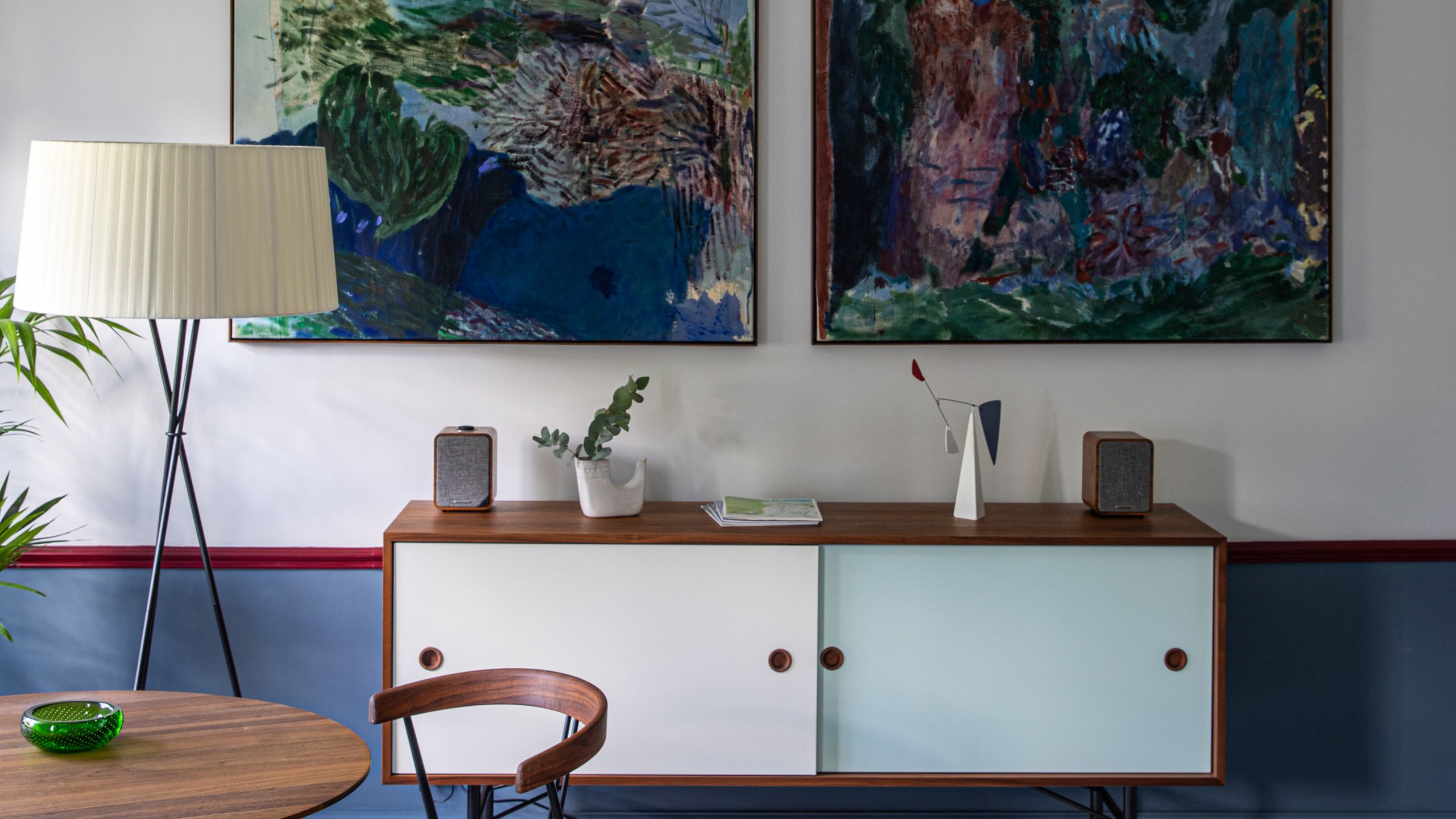 Image may contain: Furniture, Sideboard, Lamp, Book, Publication, Art, Painting, Plant, Electronics, Speaker, and Table