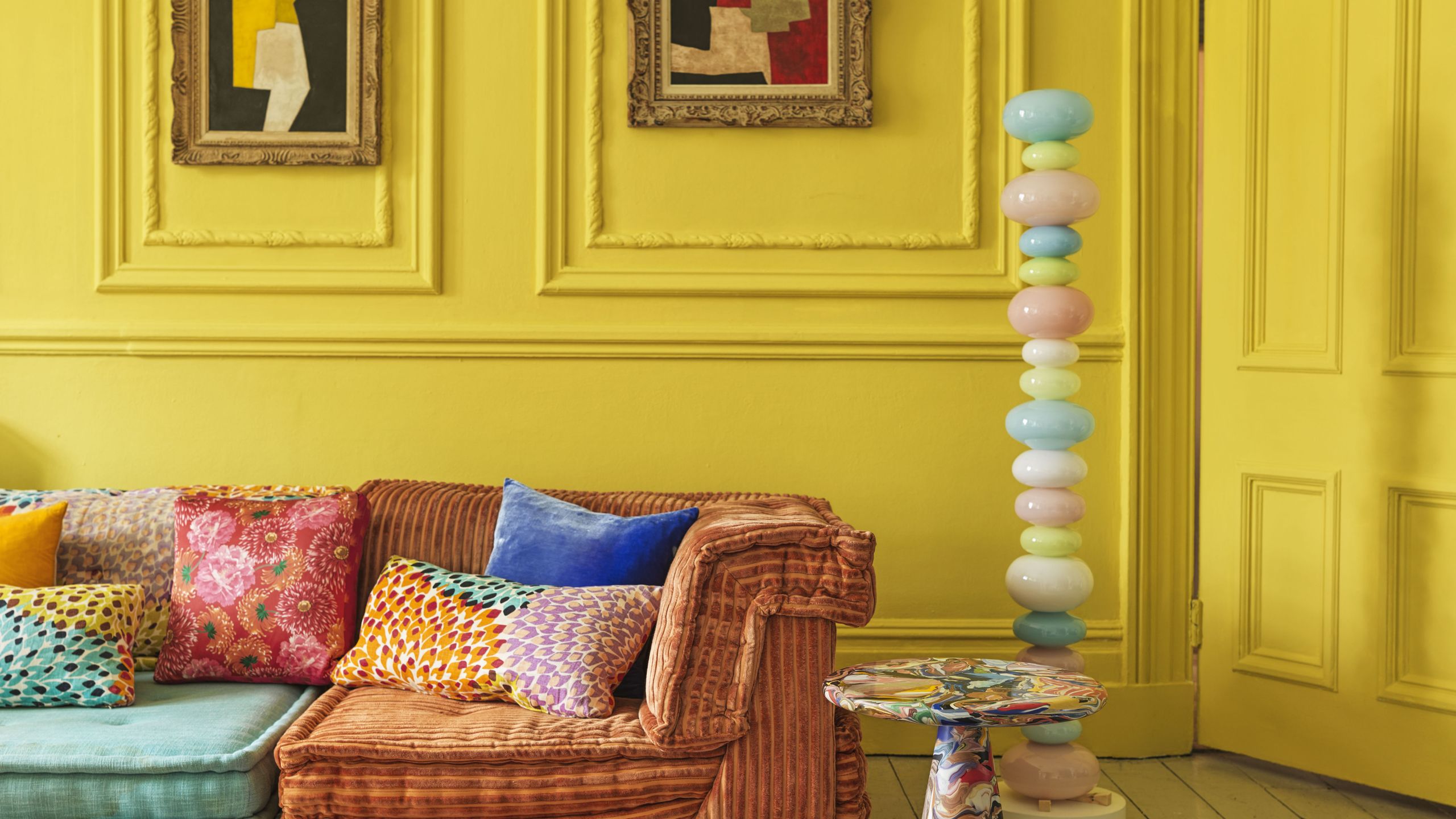 Image may contain: Cushion, Home Decor, Lamp, Indoors, Interior Design, Couch, Furniture, Art, Painting, and Pillow