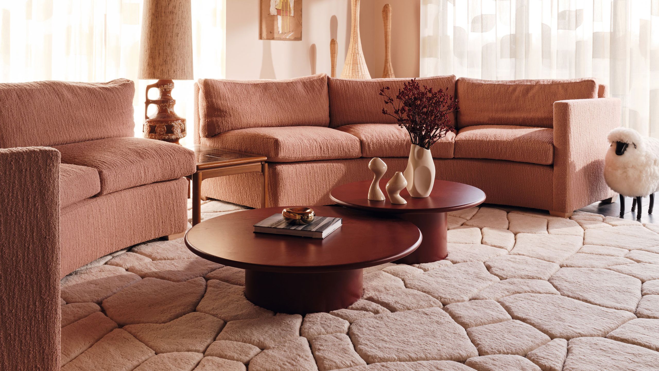 Image may contain: Coffee Table, Furniture, Table, Home Decor, Book, Publication, Rug, Couch, Lamp, and Architecture