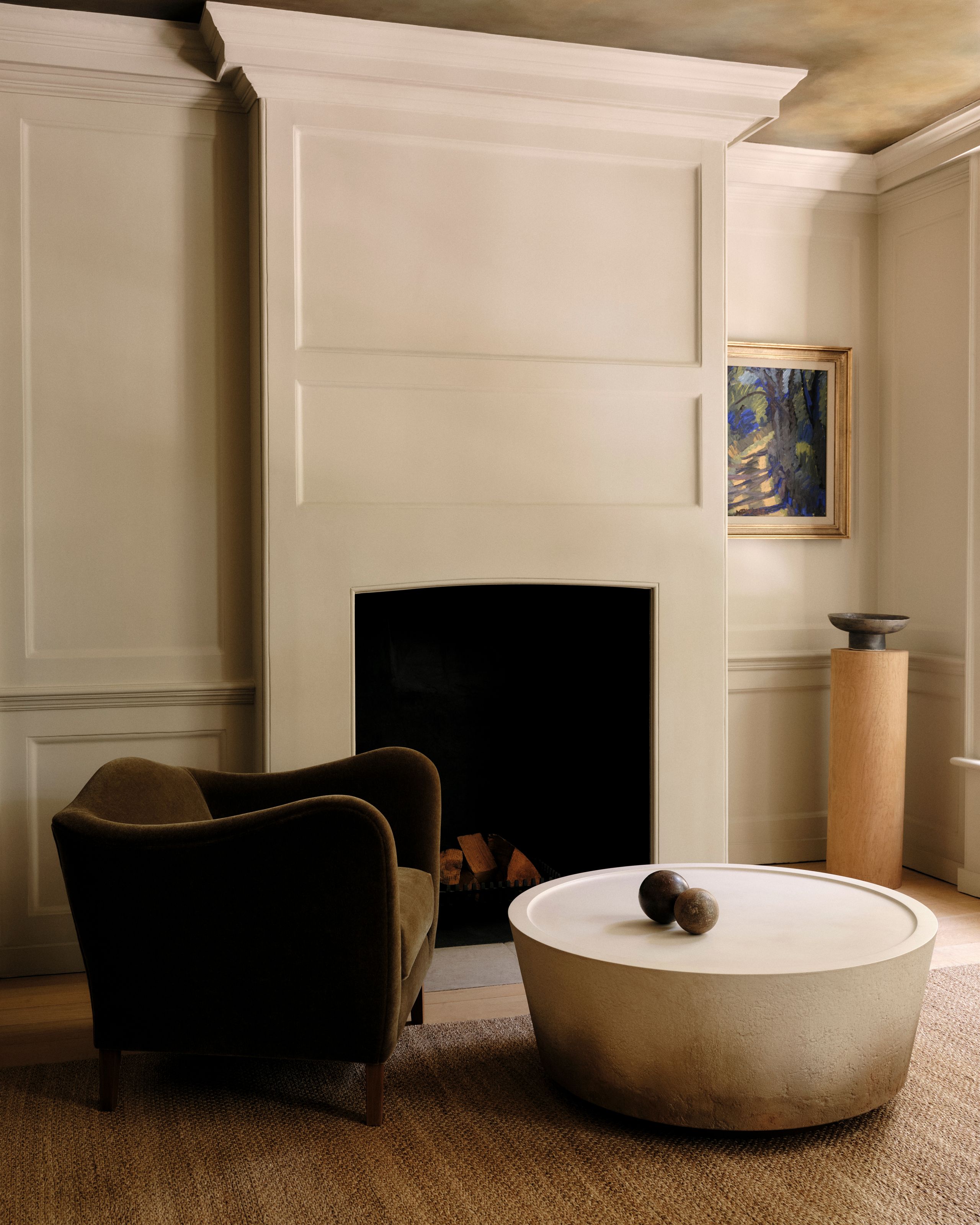 Image may contain: Fireplace, Indoors, Interior Design, Furniture, Art, Painting, Chair, and Table