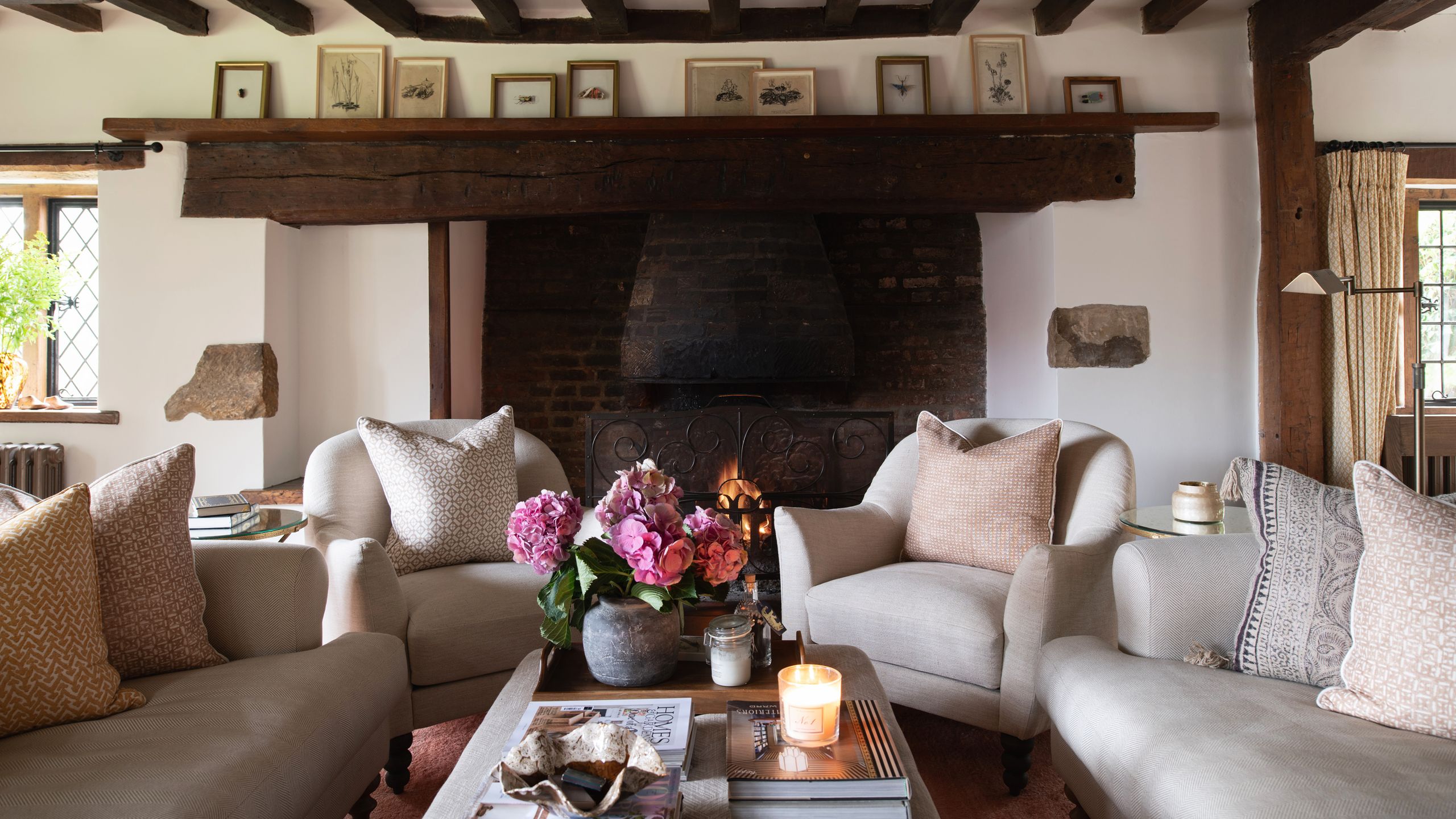 Image may contain: Home Decor, Architecture, Building, Furniture, Indoors, Living Room, Room, Table, Couch, Cushion, and Cup