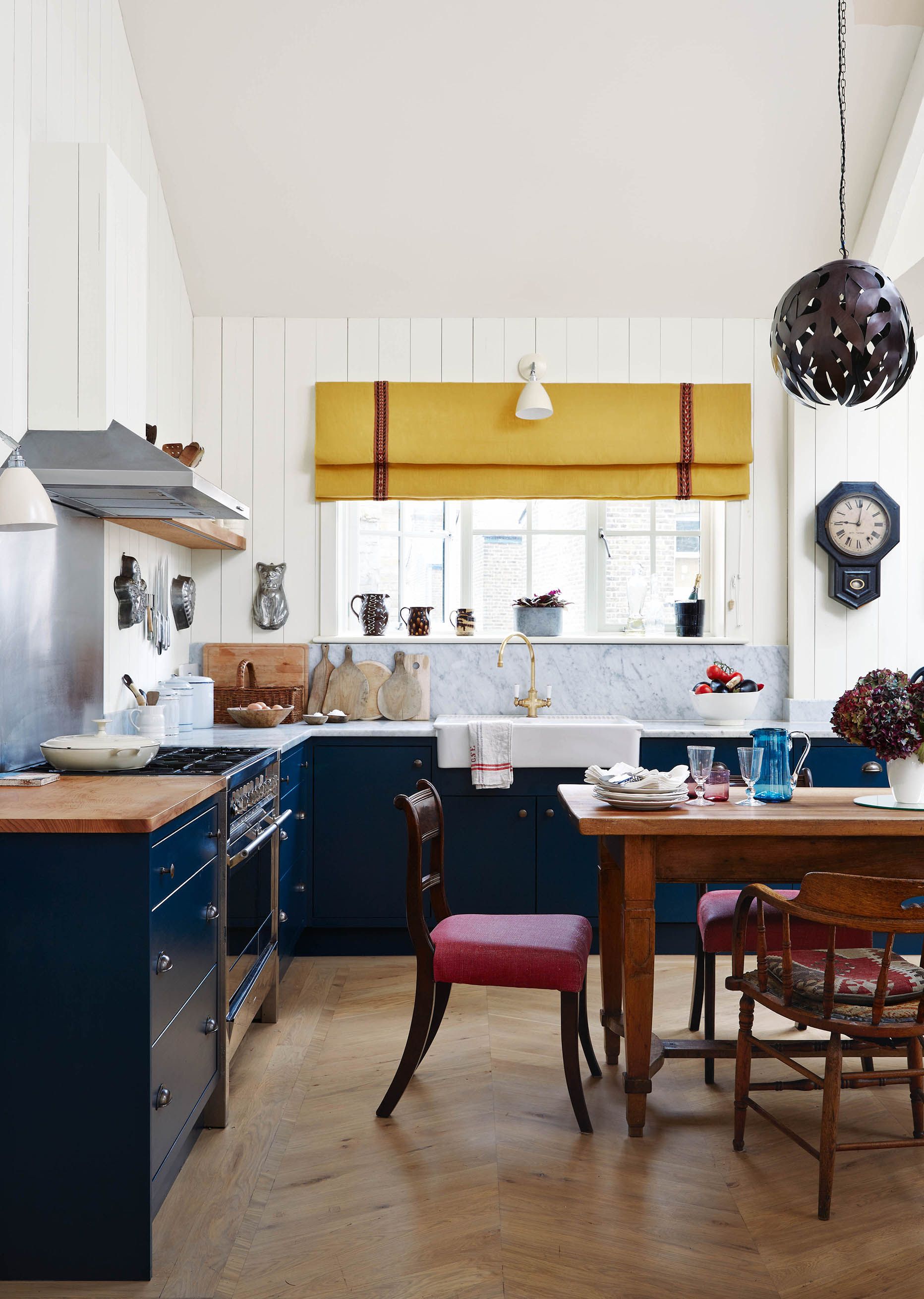 Image may contain: Indoors, Interior Design, Chair, Furniture, Kitchen, Lamp, Sink, Sink Faucet, Dining Table, and Table