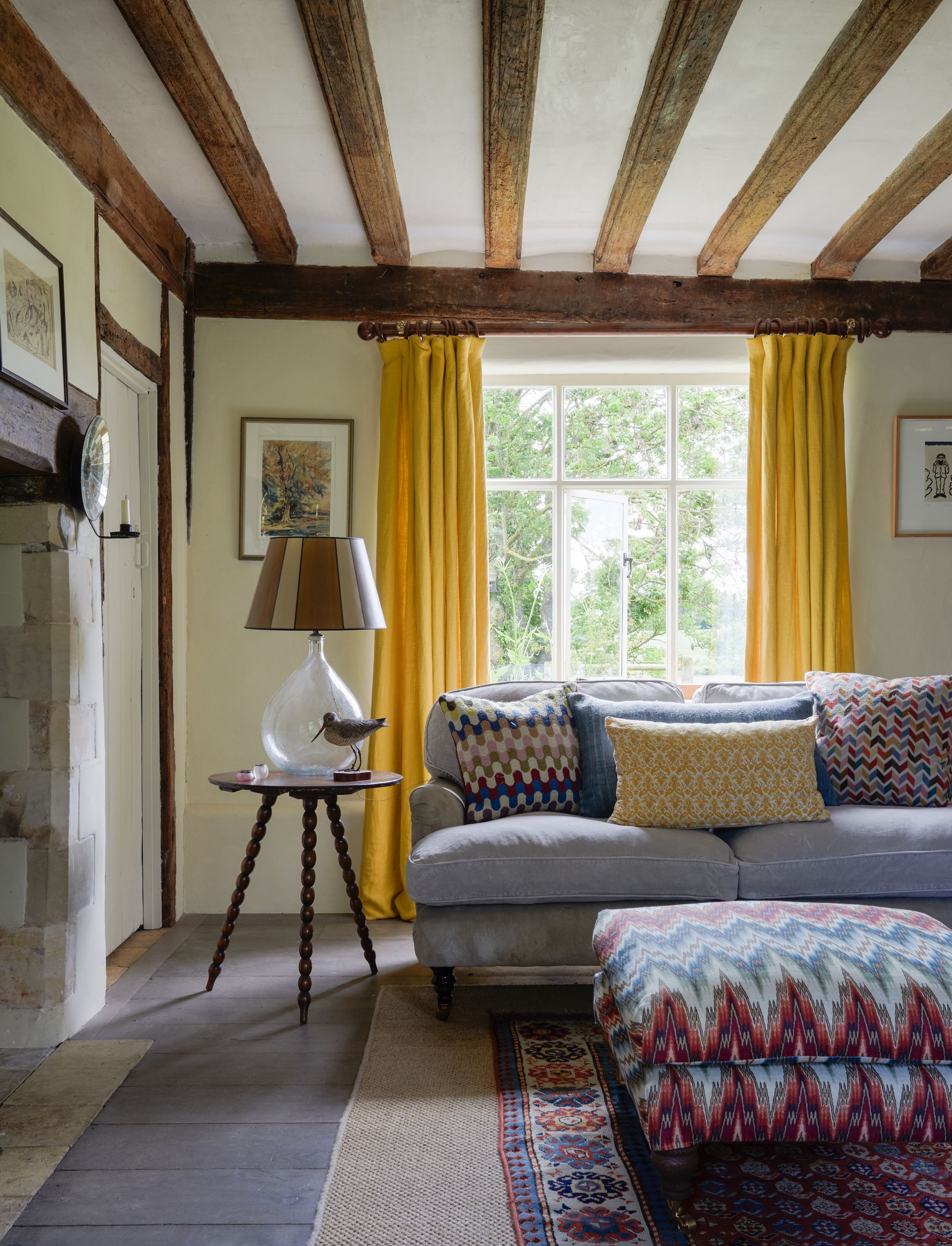 Image may contain: Lamp, Indoors, Interior Design, Home Decor, Art, Painting, Couch, Furniture, Architecture, and Building