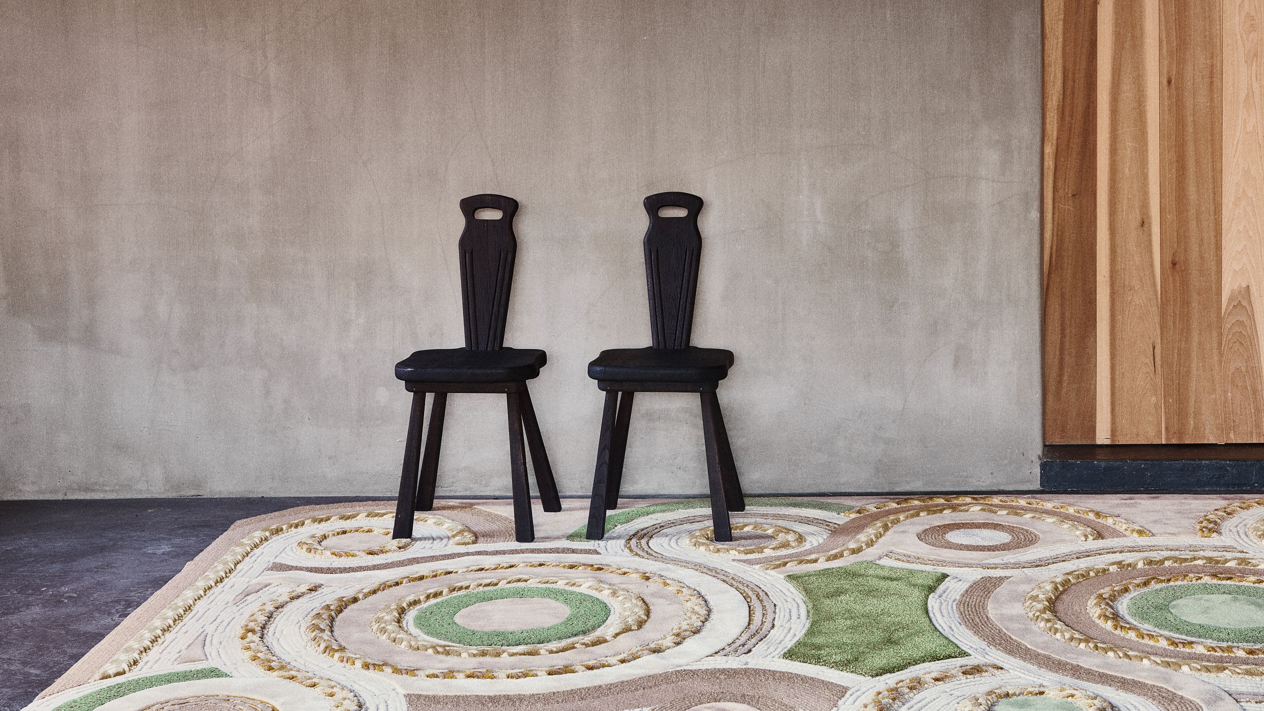 Image may contain: Home Decor, Rug, Floor, Chair, and Furniture