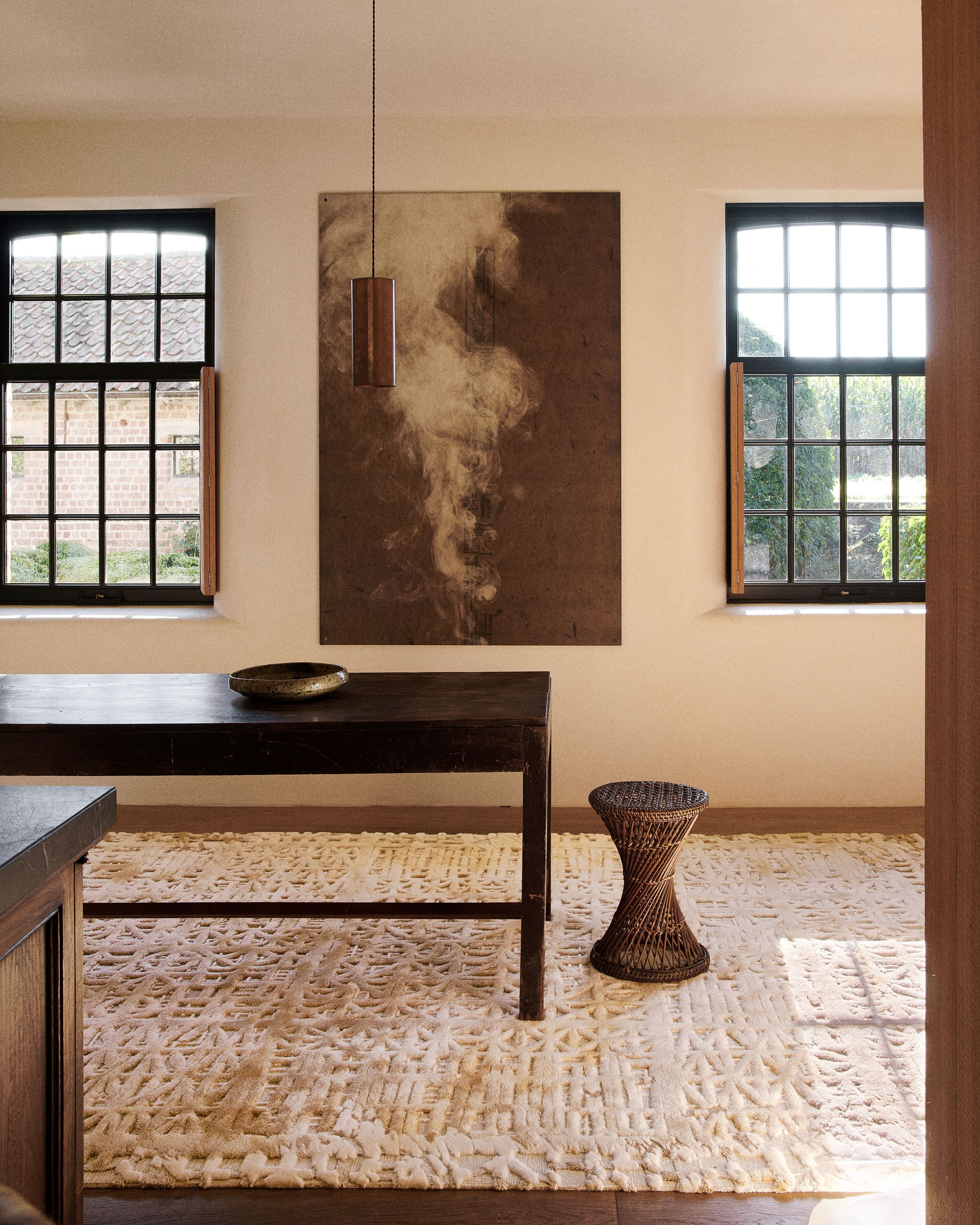 Image may contain: Home Decor, Rug, Indoors, Interior Design, Floor, Furniture, Table, Lamp, Desk, Flooring, and Plate